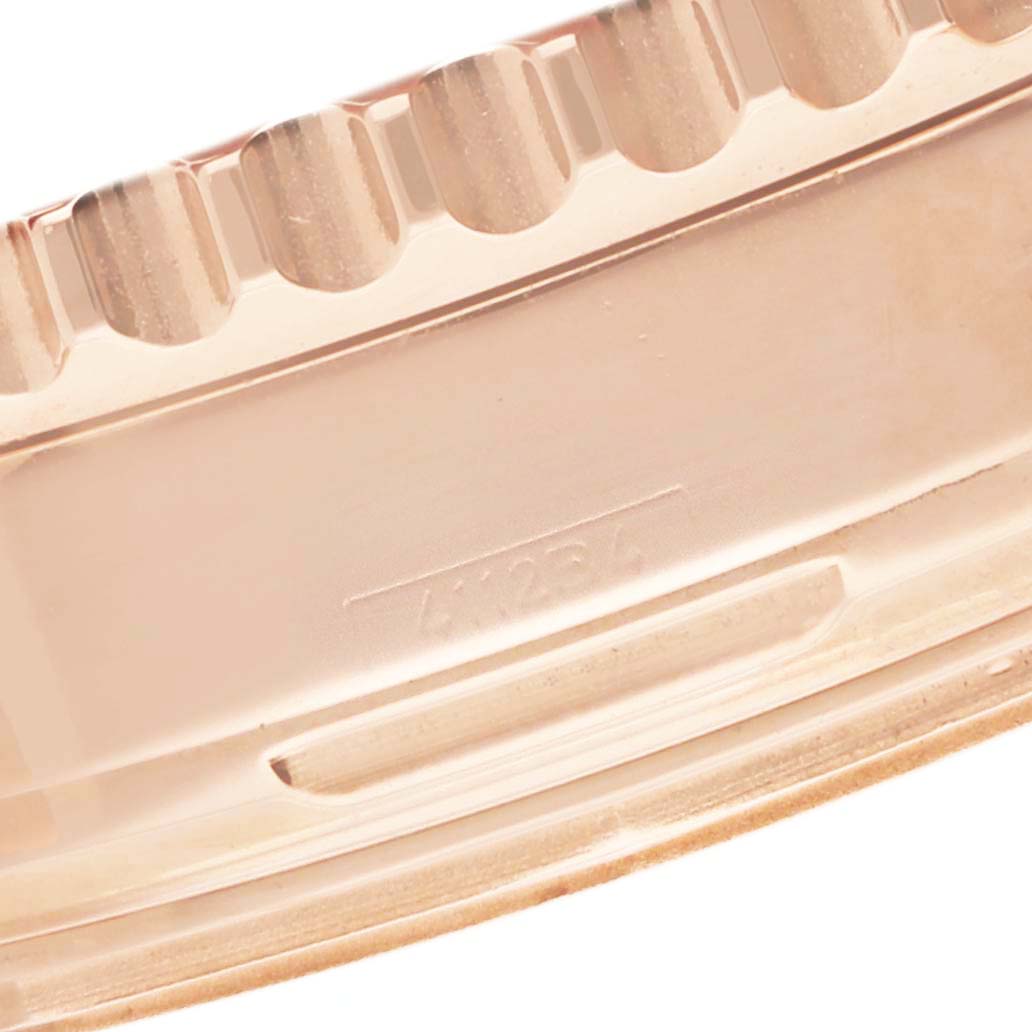 The image shows a close-up of the ridged bezel edge of a Breitling Navitimer RB0120 Men
s Rose Gold Black Dial watch from a side angle.