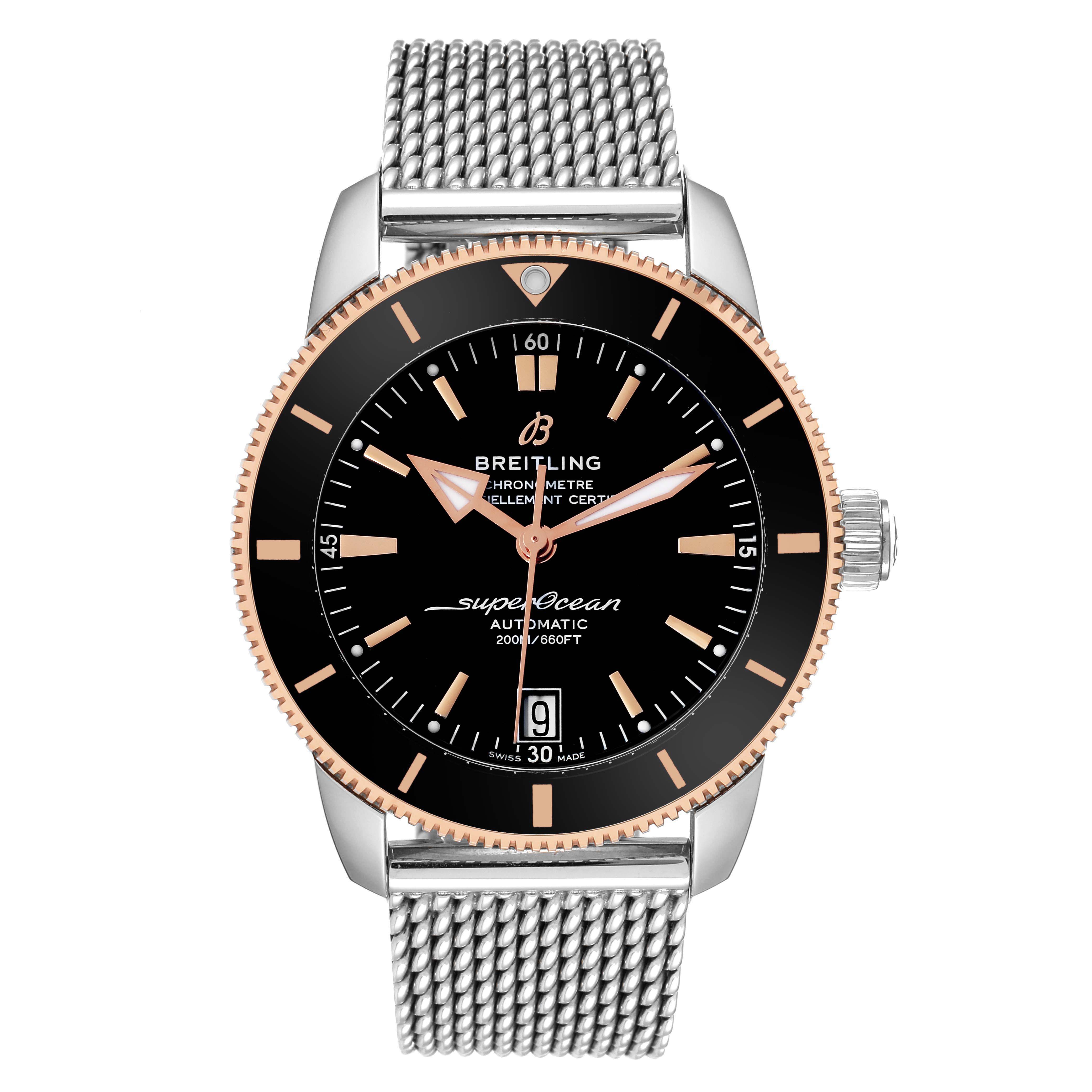 The image shows a front angle of a Breitling Superocean UB2010 Men's Steel and Gold (two tone) Black Dial UB2010 Men's Steel and Gold (two tone) Black Dial watch, displaying its face, bezel, and stainless steel mesh strap.