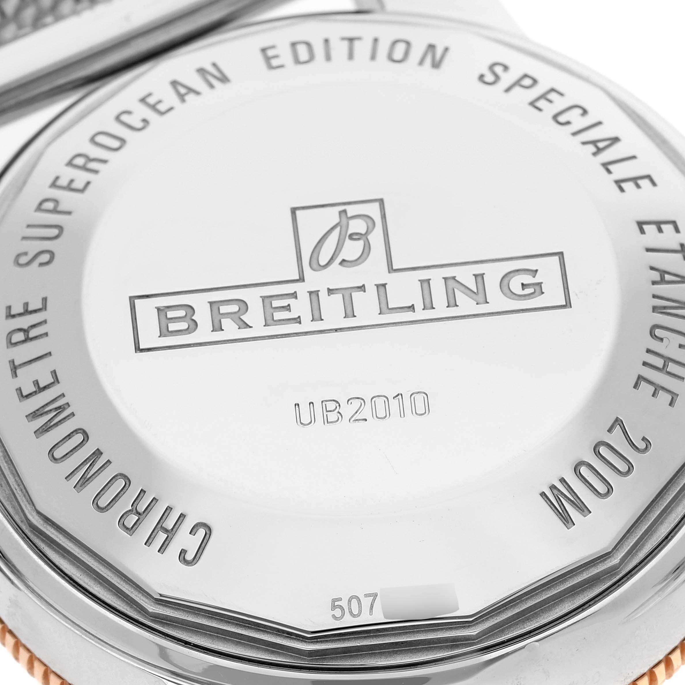 The image shows the back cover of a Breitling Superocean UB2010 Men's Steel and Gold (two tone) Black Dial UB2010 Men's Steel and Gold (two tone) Black Dial watch, highlighting model details and branding.