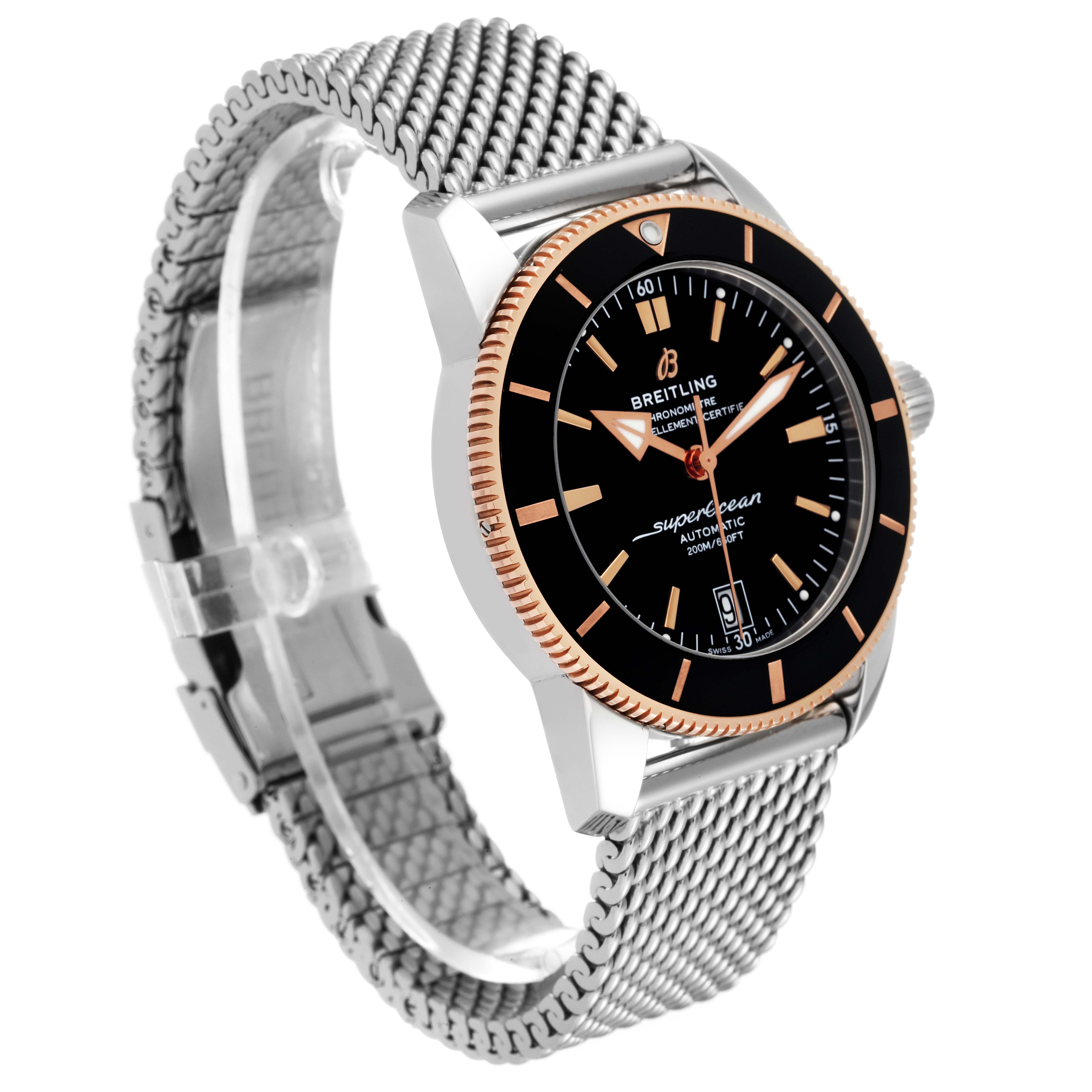This image shows a side angle of the Breitling Superocean UB2010 Men's Steel and Gold (two tone) Black Dial UB2010 Men's Steel and Gold (two tone) Black Dial watch, highlighting the face, bezel, and metal mesh strap.