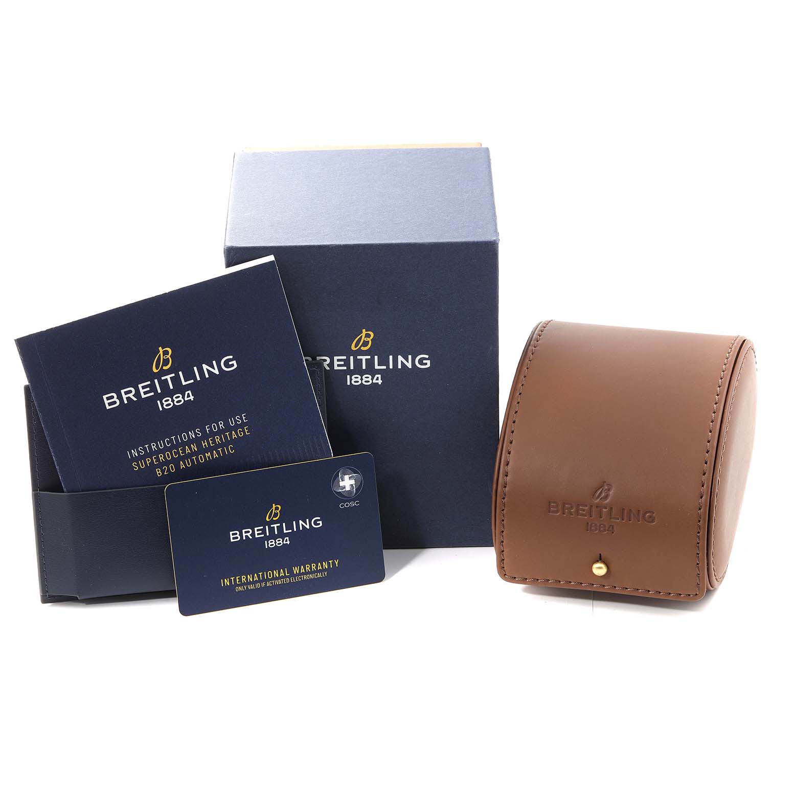 The image shows accessories for a Breitling Superocean UB2010 Men's Steel and Gold (two tone) Black Dial UB2010 Men's Steel and Gold (two tone) Black Dial watch, including a box, instruction manual, warranty card, and leather case.