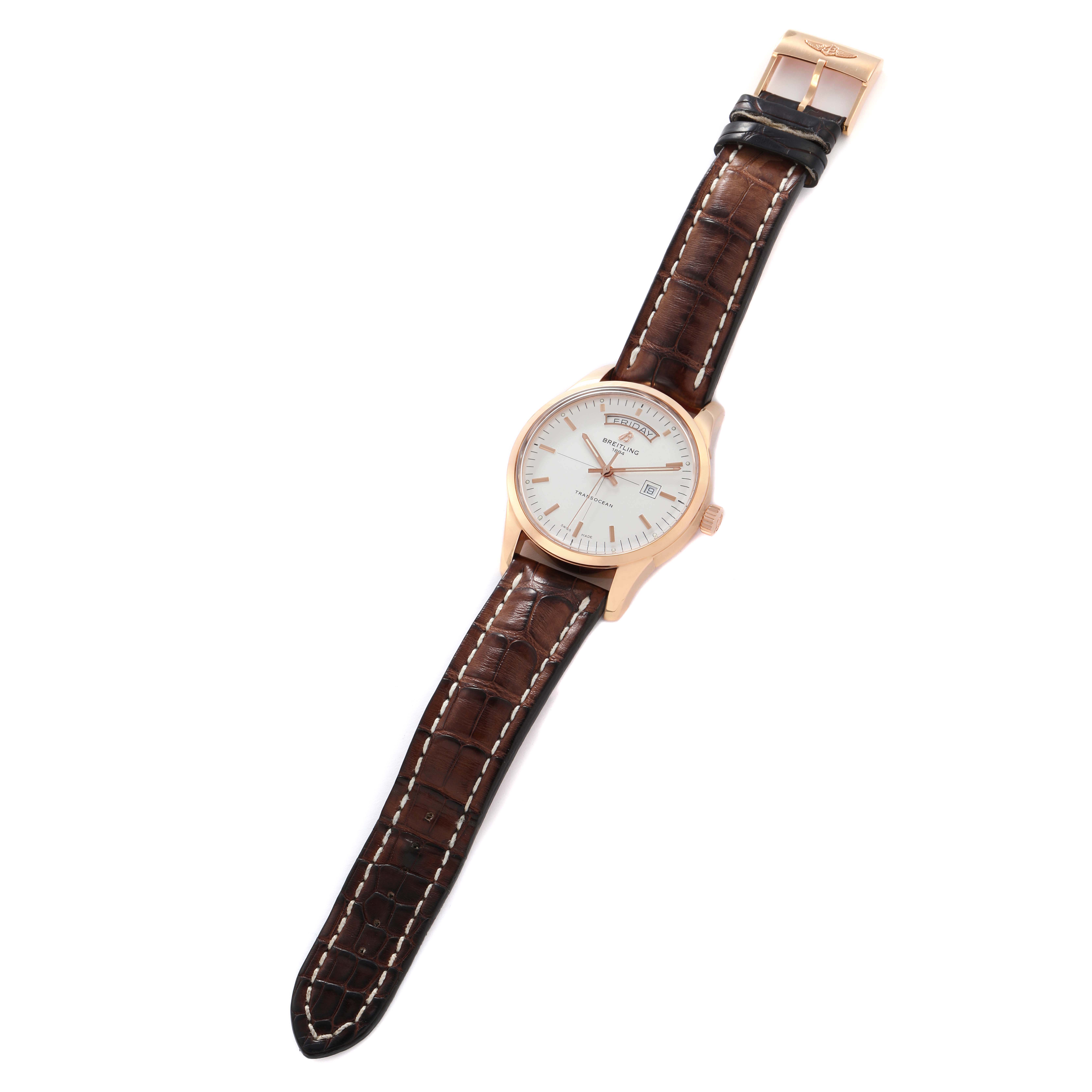 The Breitling Transocean R45310 Men's Rose Gold Silver Dial watch is shown from a top-down angle, displaying the dial, case, and leather strap with a visible buckle.