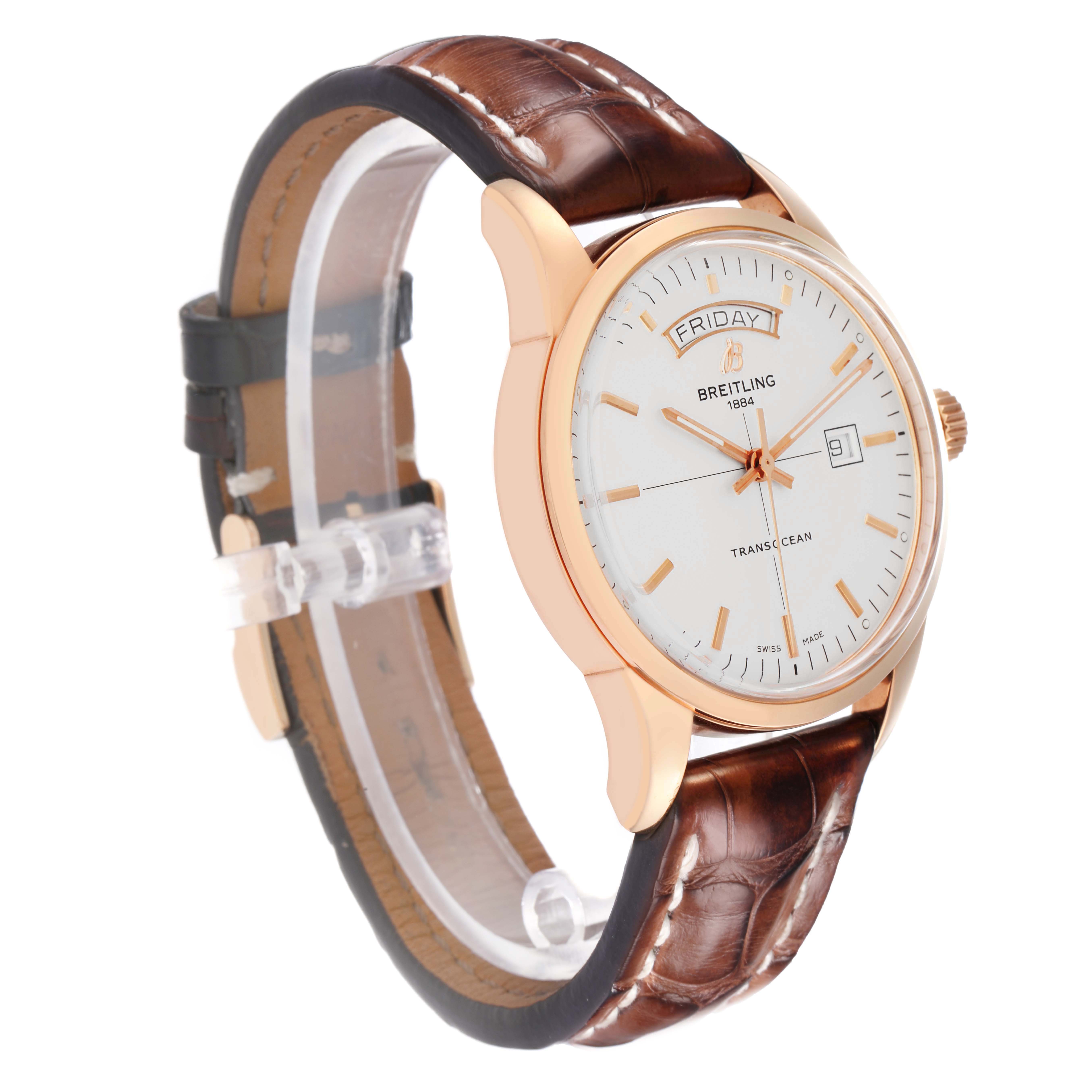 The Breitling Transocean R45310 Men's Rose Gold Silver Dial watch is shown from an angled side view, highlighting the dial, strap, and crown.