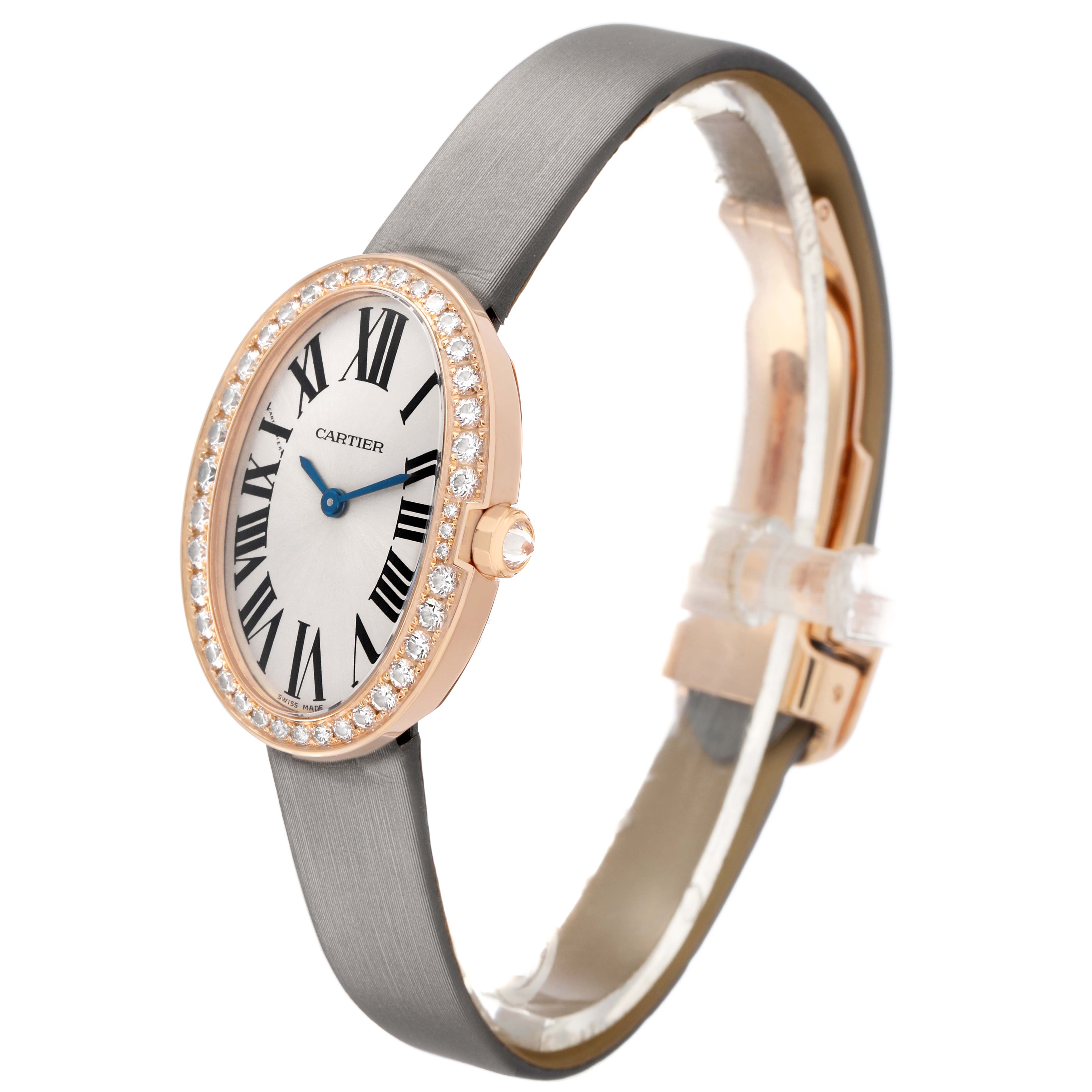 The Cartier Baignoire WB520004 Women's Rose Gold Silver Dial watch is shown at a side angle, highlighting the oval face, diamond bezel, and black strap.
