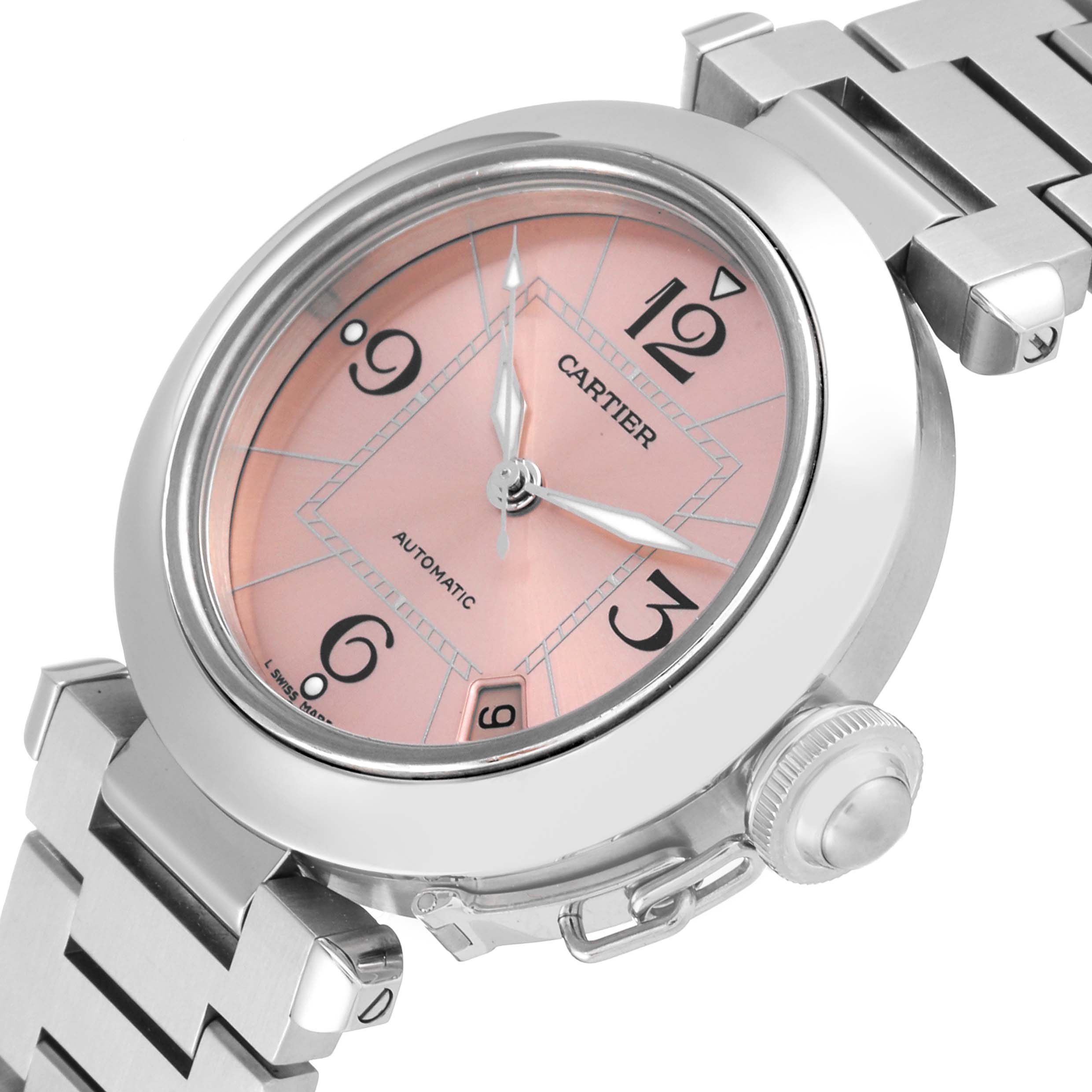 The image shows a close-up, angled view of the Cartier Pasha W31075M7 Women's Stainless Steel Pink Dial W31075M7 Women's Stainless Steel Pink Dial watch, focusing on the pink dial, bracelet, and crown.