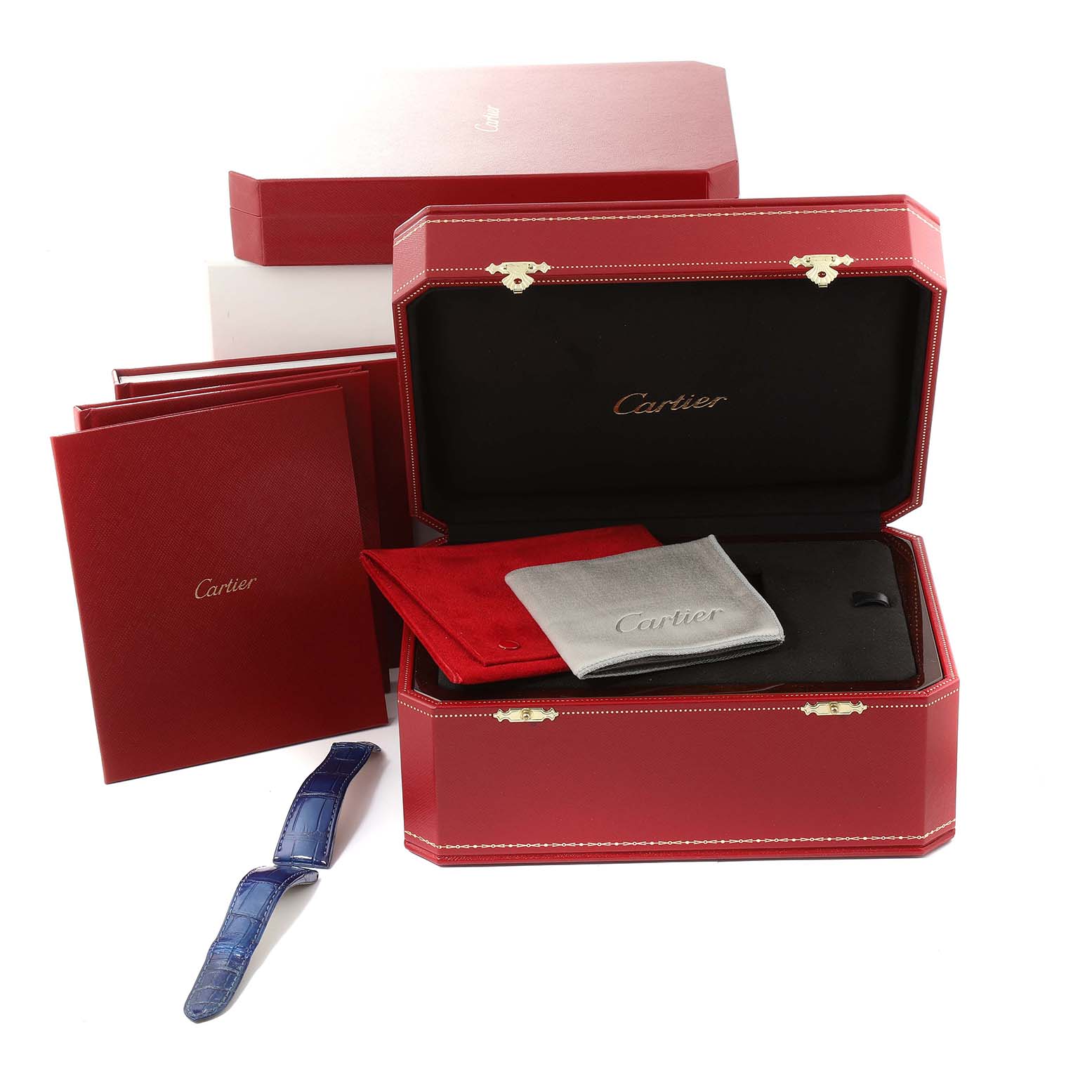 This image shows the packaging and accessories for a Cartier Rotonde W1556224 Men's White Gold Silver Dial W1556224 Men's White Gold Silver Dial model watch, including a red case, booklets, and a blue strap.