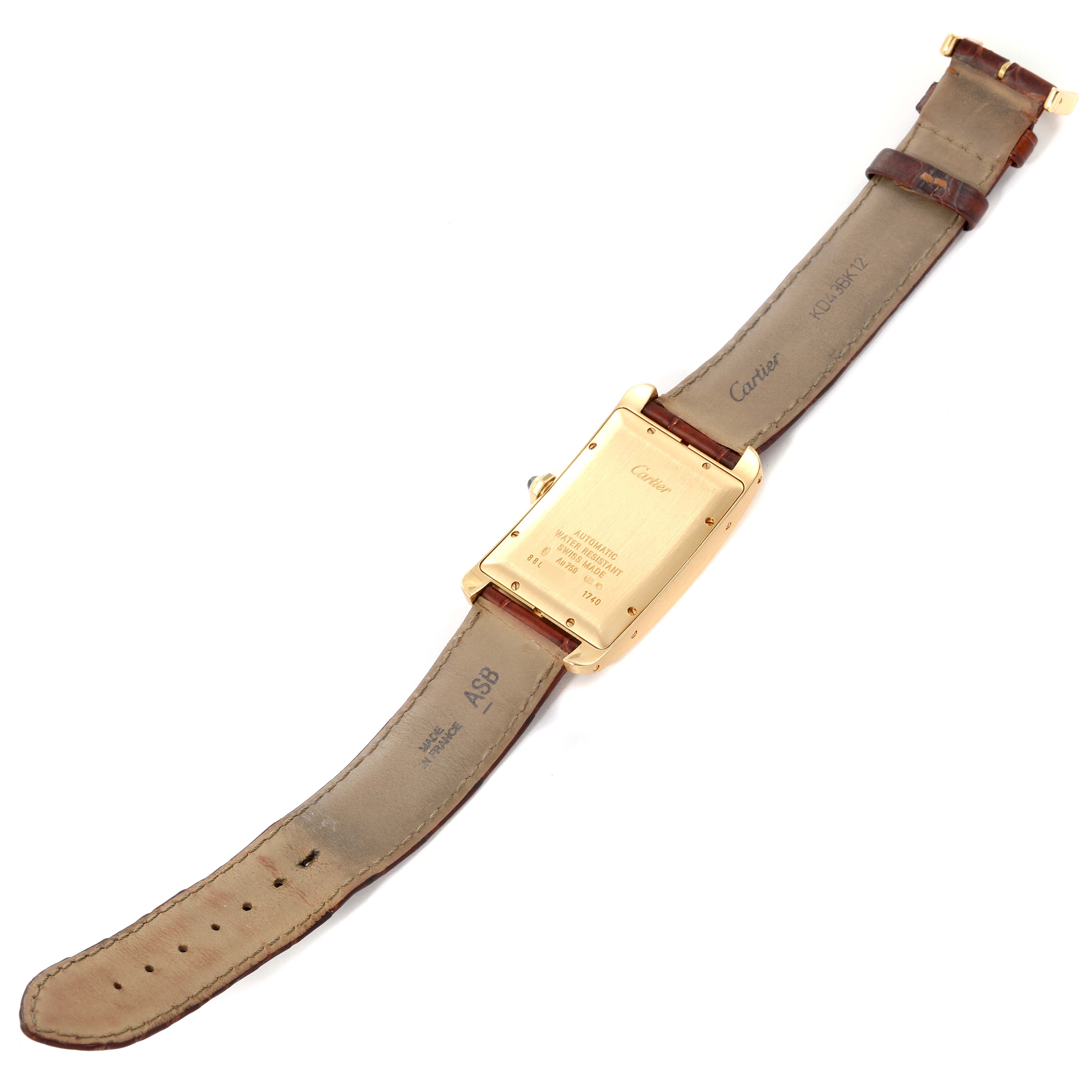 The image shows the back side of a Cartier Tank Américaine model, including its case and leather strap.