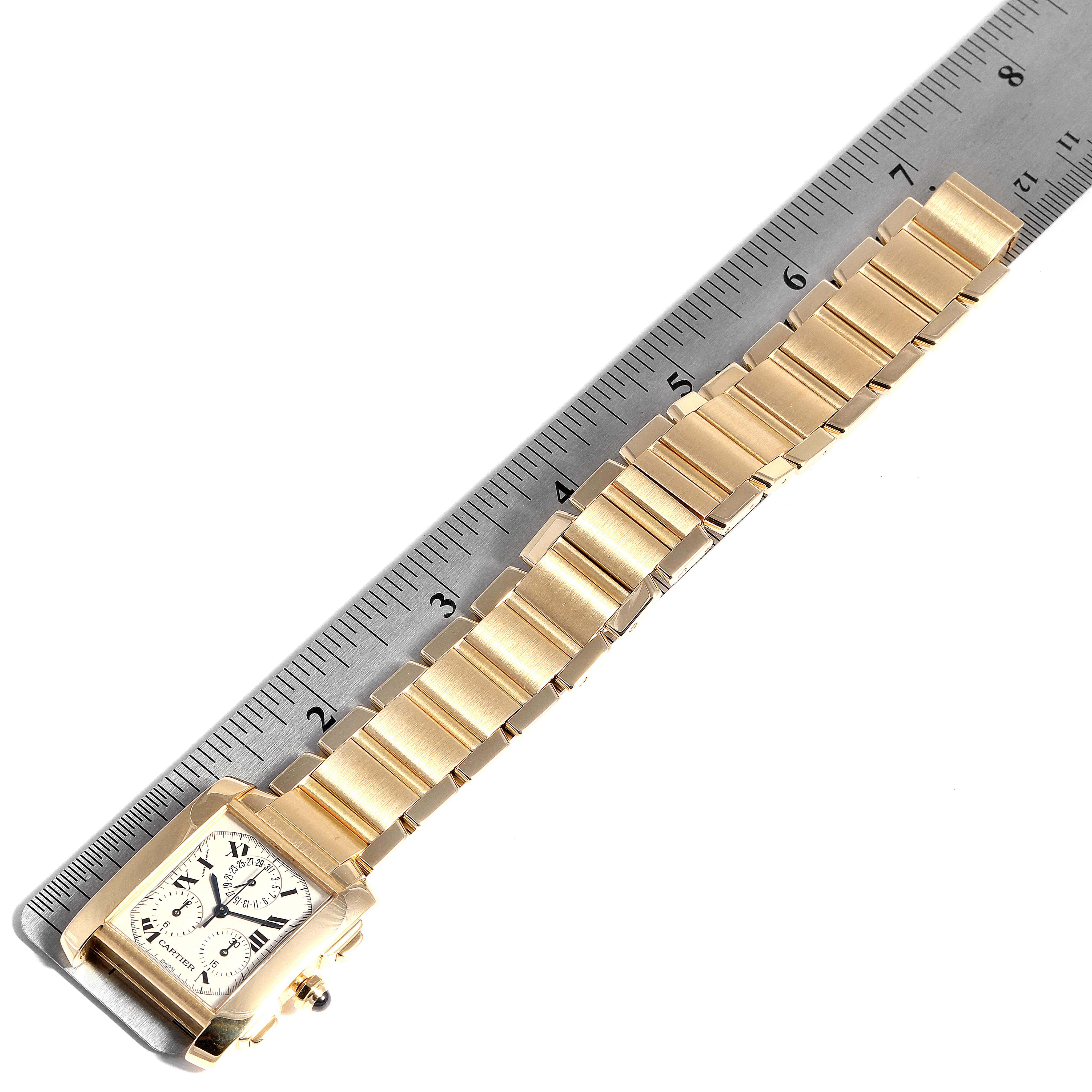 The image shows a gold Cartier Tank Francaise W50005R2 Men's Yellow Gold Silver Dial W50005R2 Men's Yellow Gold Silver Dial watch laid flat with a ruler measuring its length.
