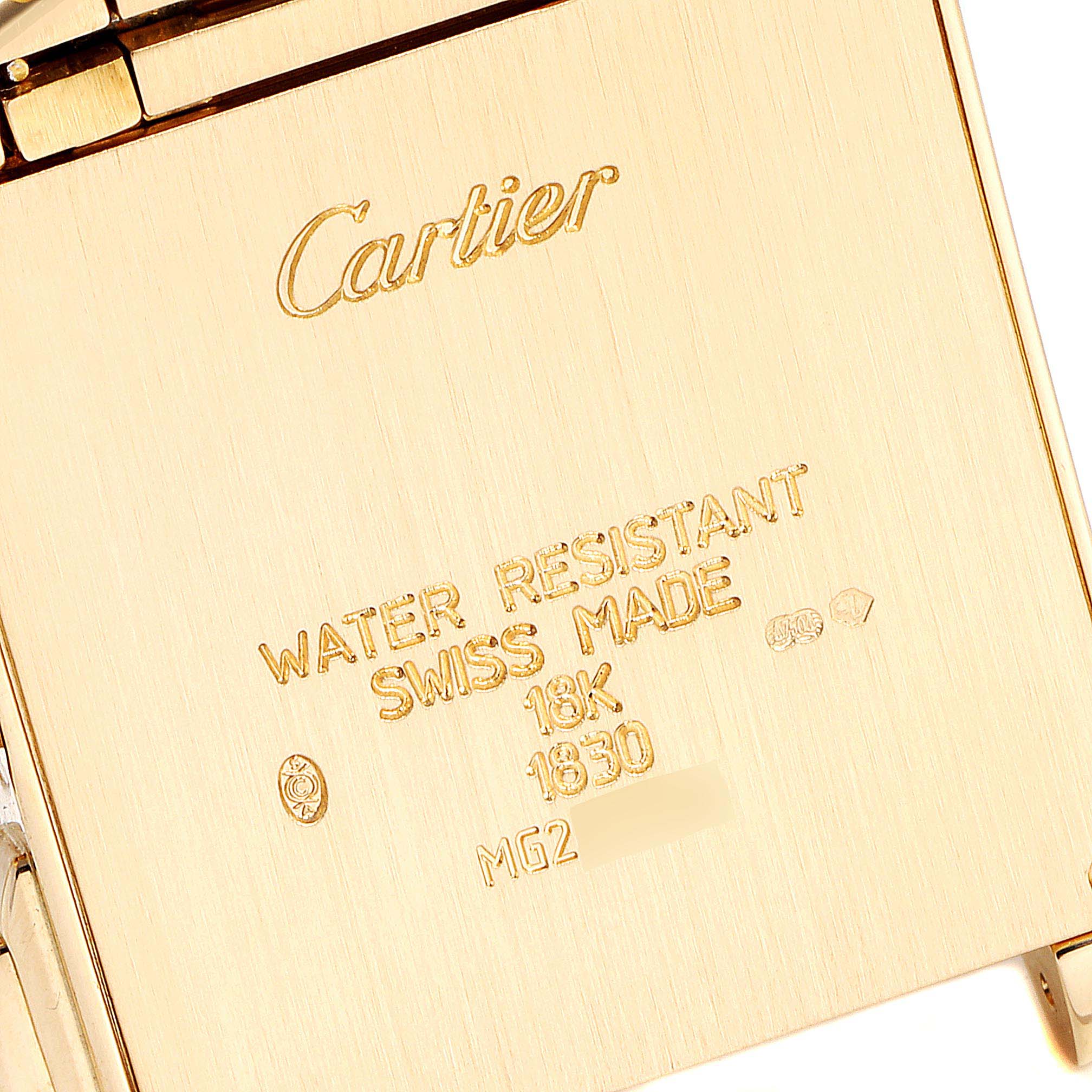 This image shows a close-up of the back case of a Cartier Tank Francaise W50005R2 Men's Yellow Gold Silver Dial W50005R2 Men's Yellow Gold Silver Dial watch, highlighting the brand's engraving and specifications.