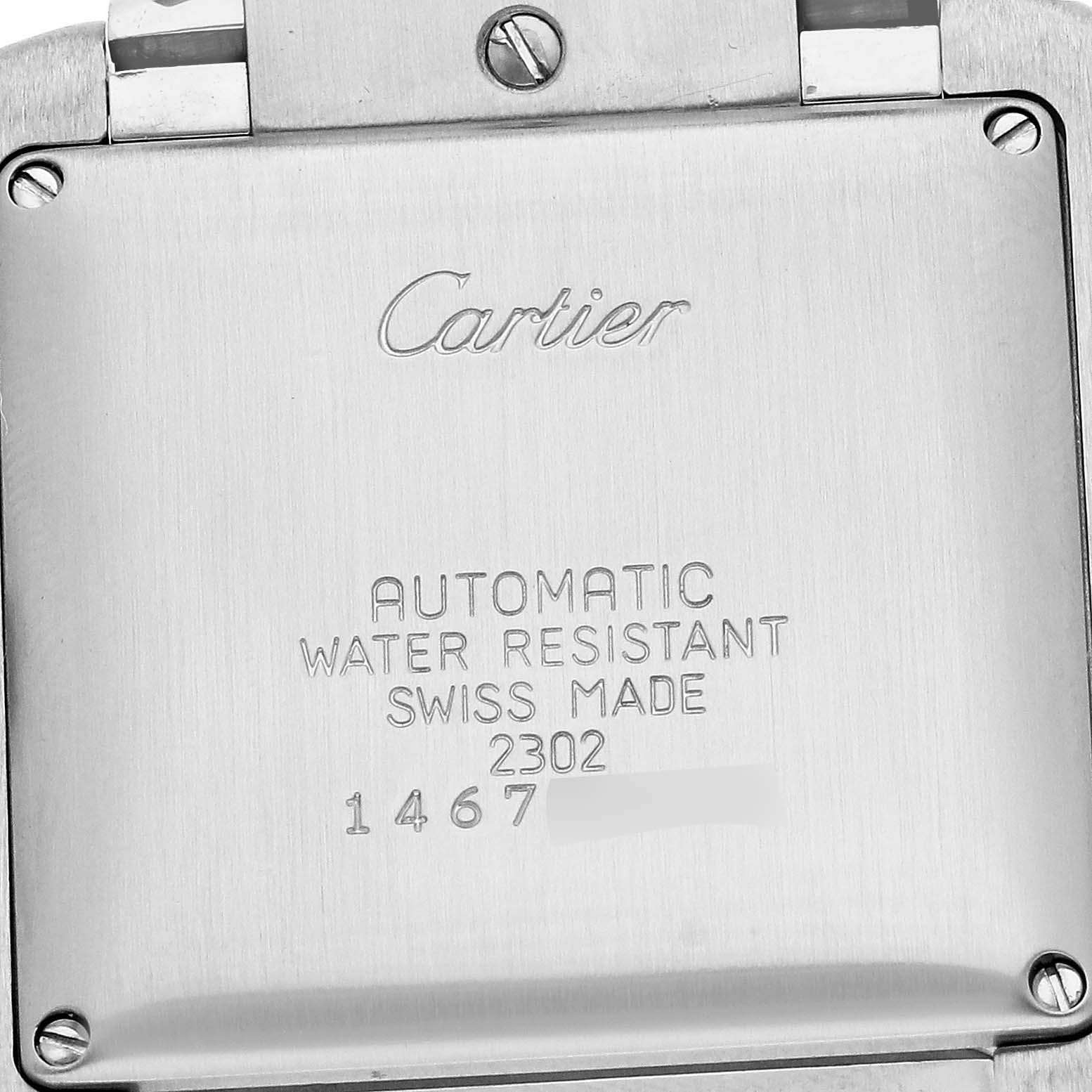 The image shows the back case of a Cartier Tank Francaise W51002Q3 Men
s Stainless Steel Silver Dial watch, displaying engravings and screws.