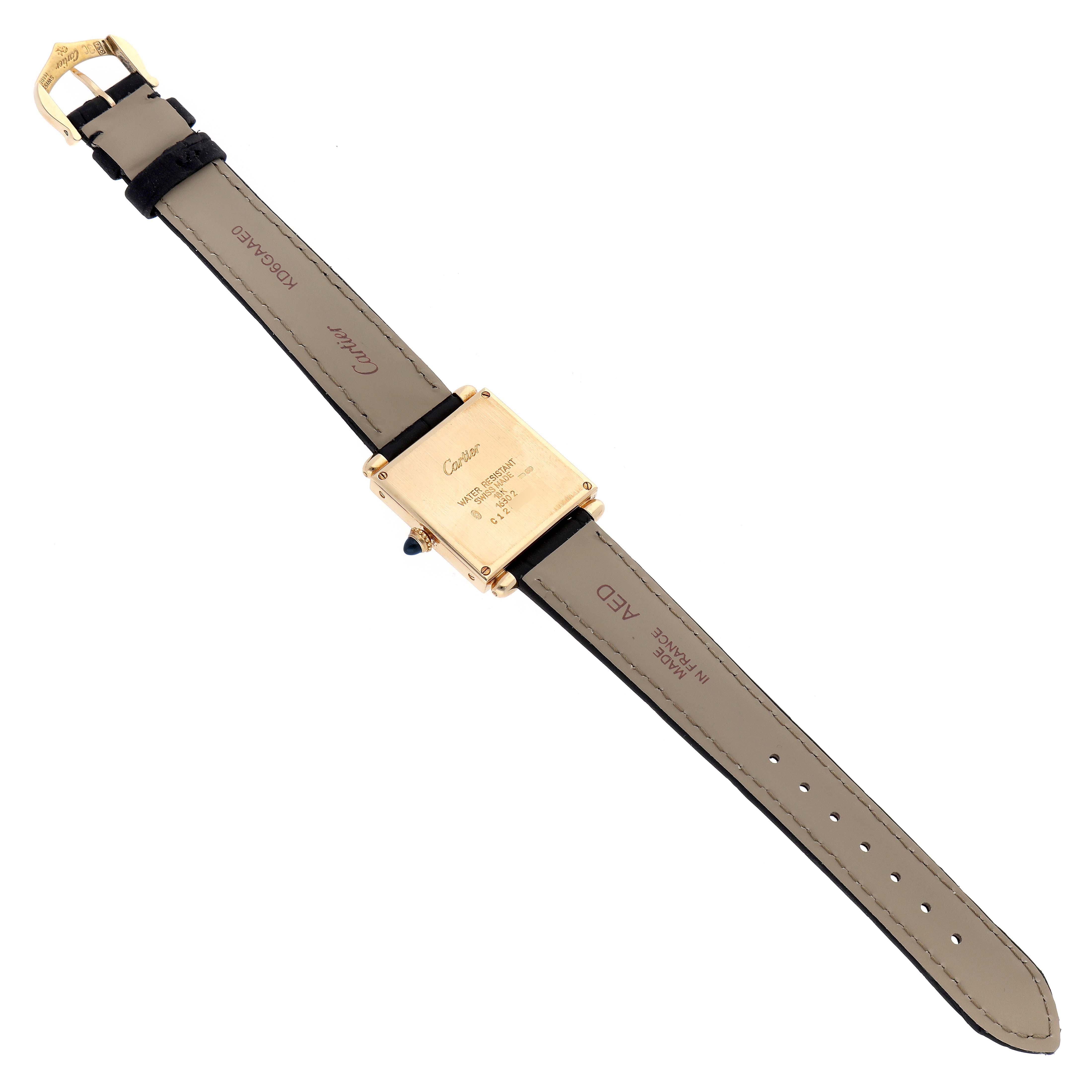 The Cartier Tank Obus W1512256 Women
s Yellow Gold Silver Dial watch is shown from the back, displaying the case, strap, and buckle.