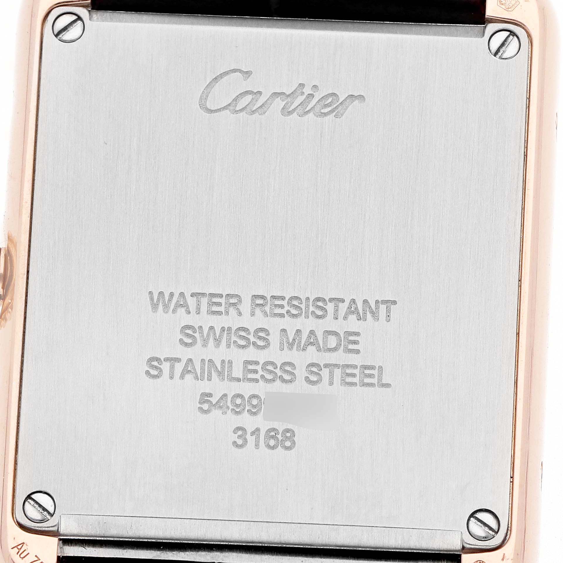 The image shows the back plate of the Cartier Tank Solo W5200024 Women
s Rose Gold Silver Dial watch, highlighting brand engravings and material details.