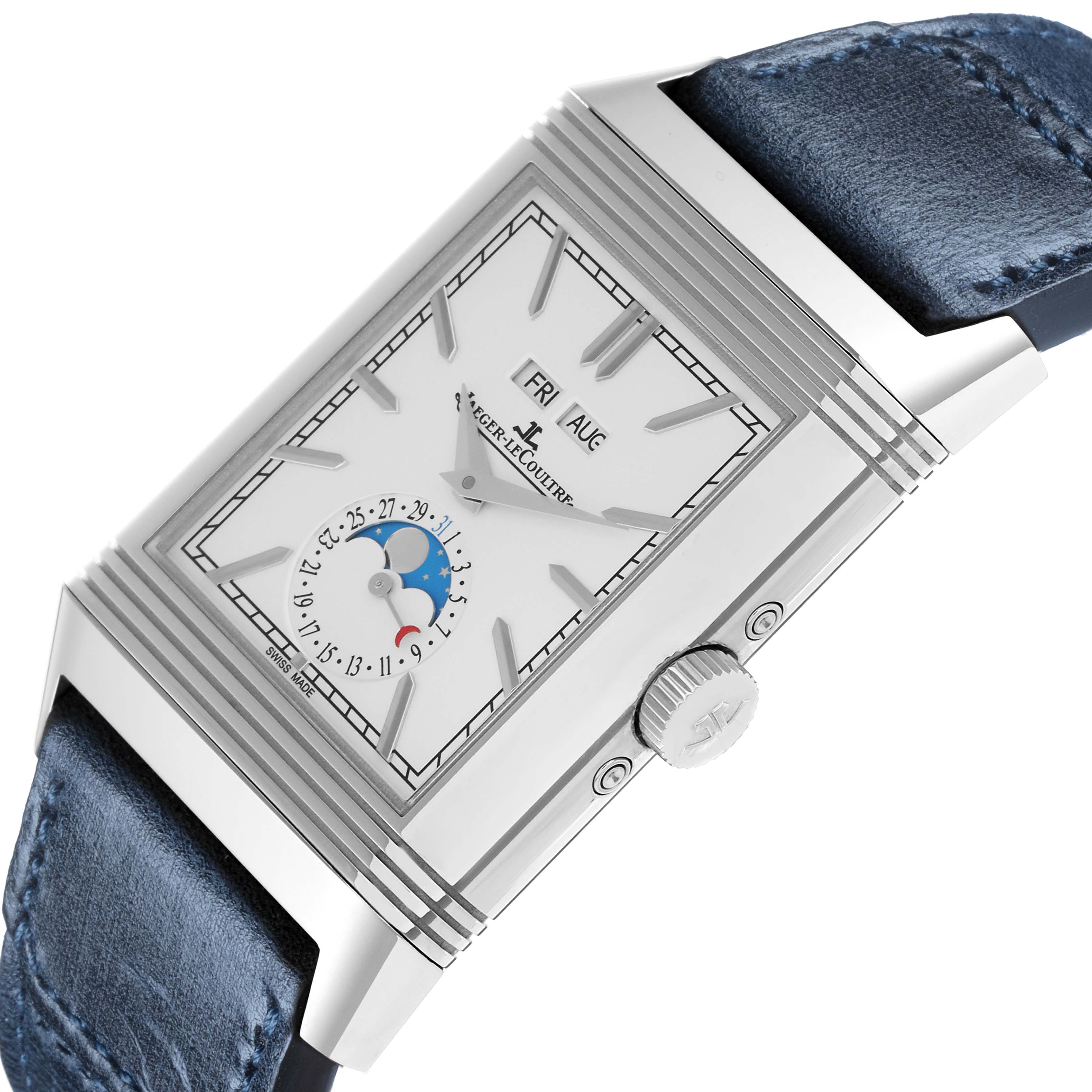 The Jaeger-LeCoultre Reverso watch is shown from a slightly angled top view, highlighting the dial, case, and part of the blue strap.