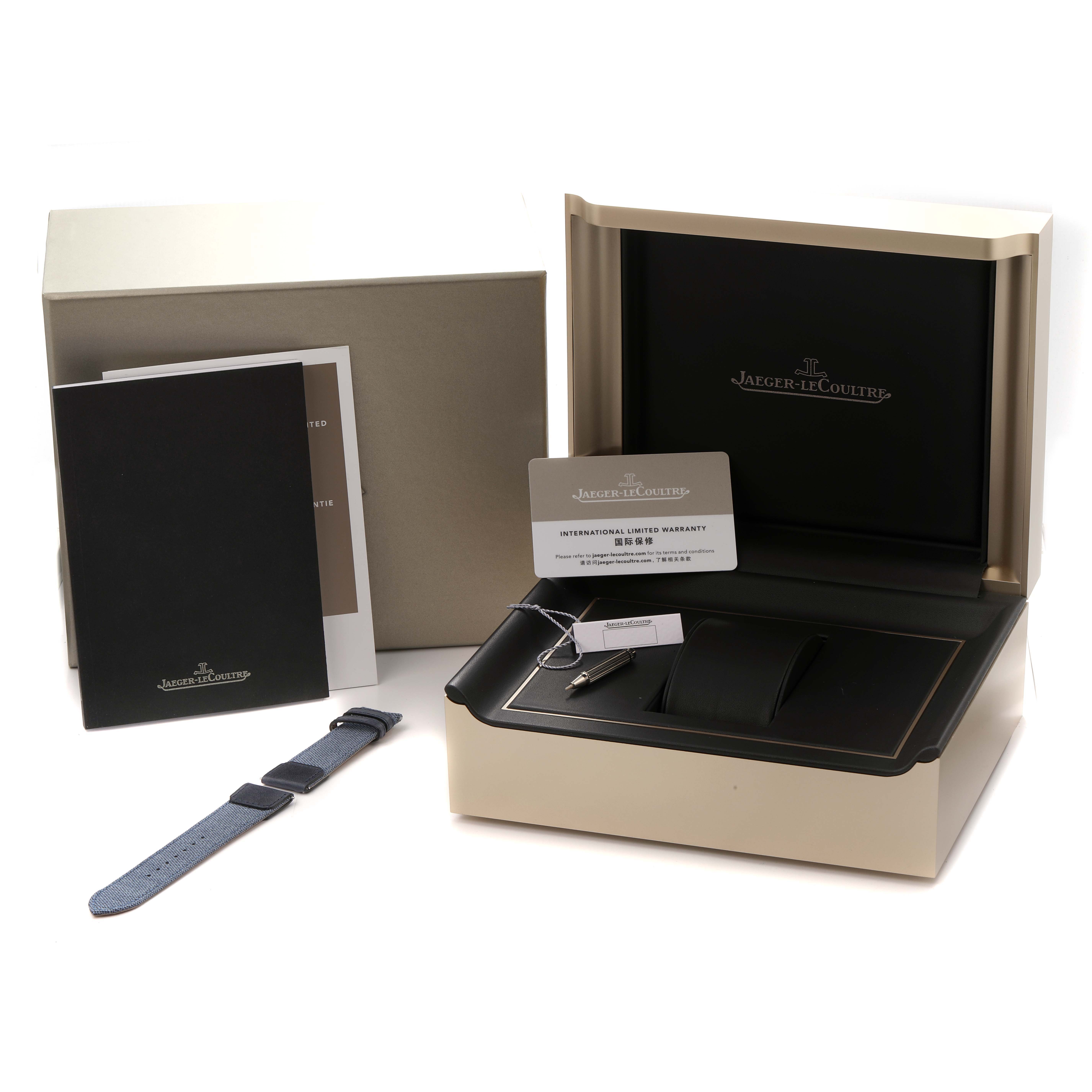The image shows the packaging and accessories for the Jaeger LeCoultre Reverso Q3918420 Men
s Stainless Steel Silver Dial watch, including the box, extra strap, and documents.