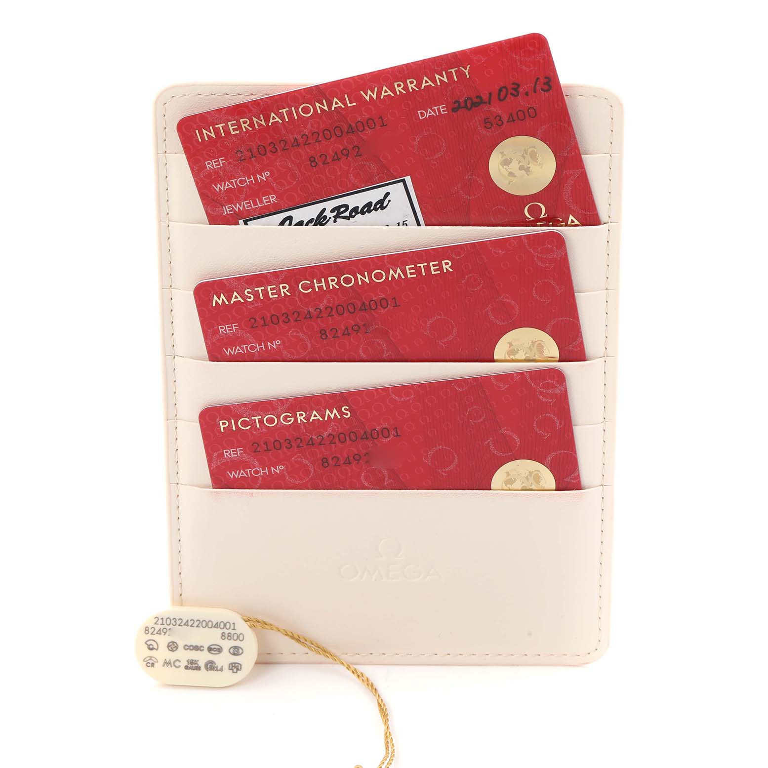 The image shows the warranty cards and a tag for the Omega Seamaster 210.32.42.20.04.001 Men
s Stainless Steel White Dial, arranged in a holder.