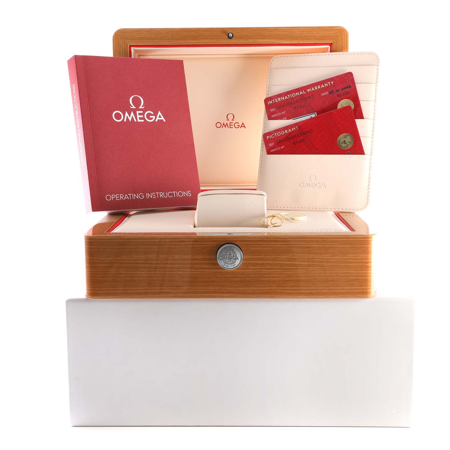 The image shows a wooden Omega Speedmaster 331.10.42.51.02.002 Men
s Stainless Steel Silver Dial 331.10.42.51.02.002 Men
s Stainless Steel Silver Dial watch box with operating instructions and warranty cards displayed on top.