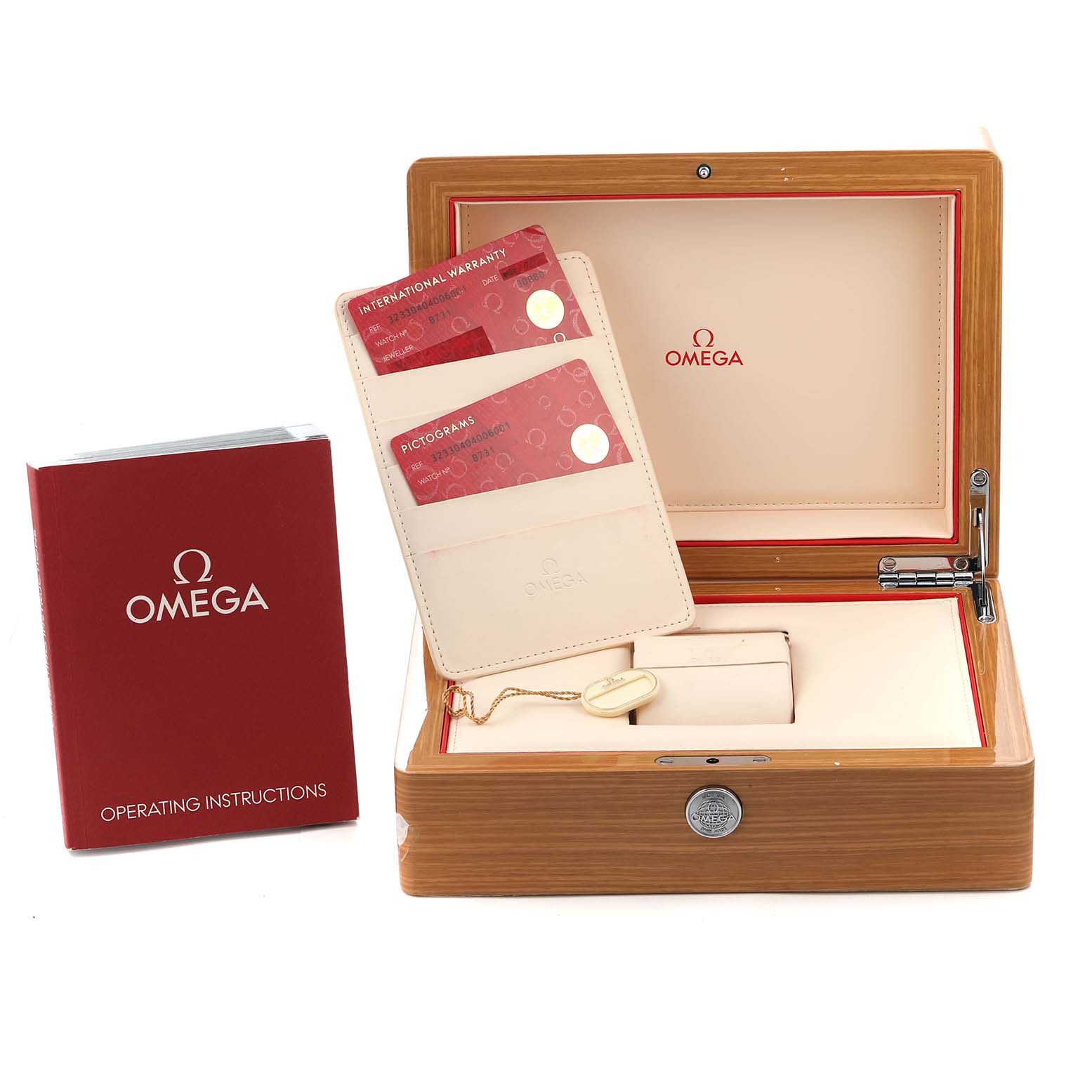 The image shows an open Omega Speedmaster 323.30.40.40.06.001 Men
s Stainless Steel Grey Dial wooden box, warranty cards, and operating instructions booklet from a front angle.