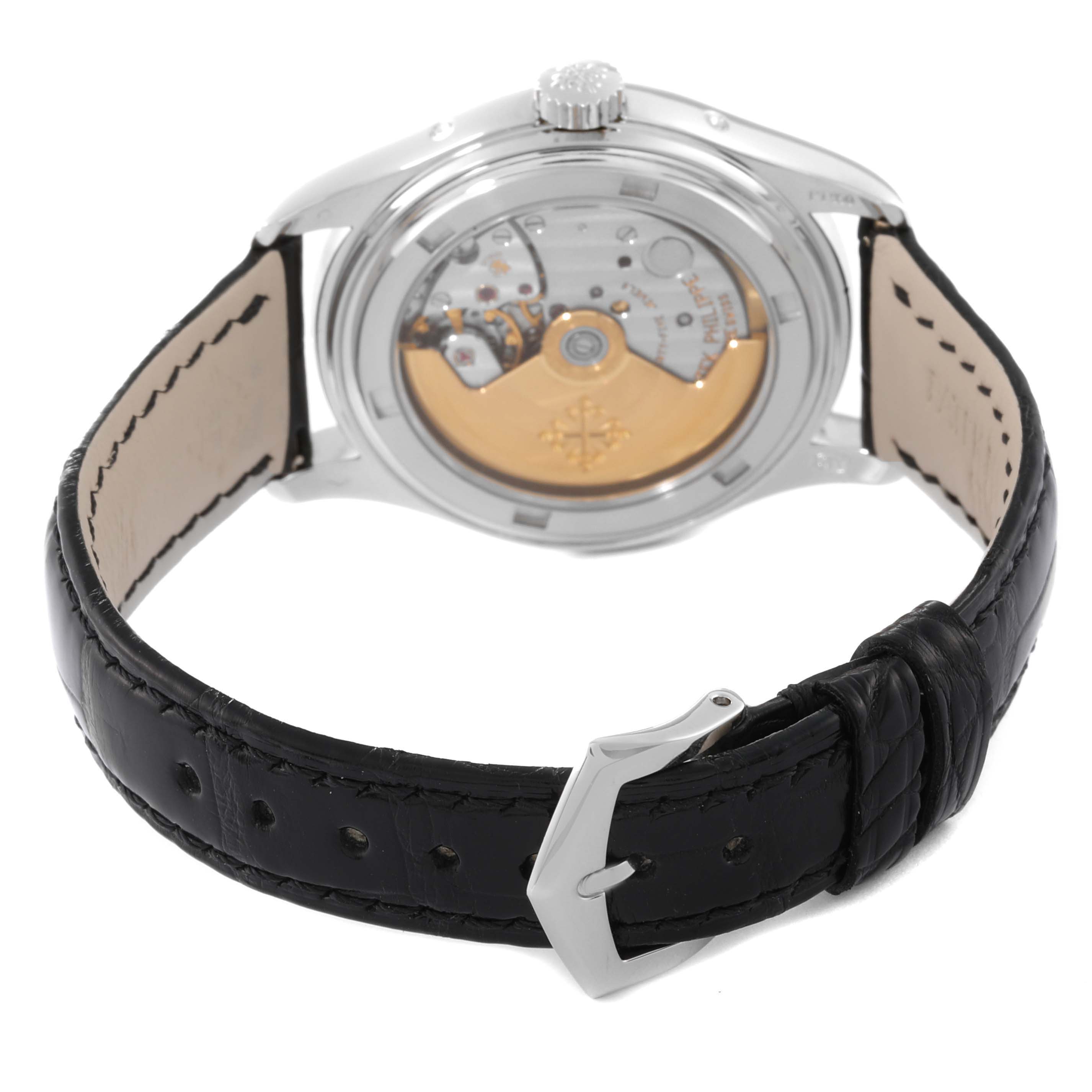 The image shows the back view of the Patek Philippe Complications 5035P-026 Men's Platinum Silver Dial 5035P-026 Men's Platinum Silver Dial watch, highlighting its transparent case back and black leather strap.