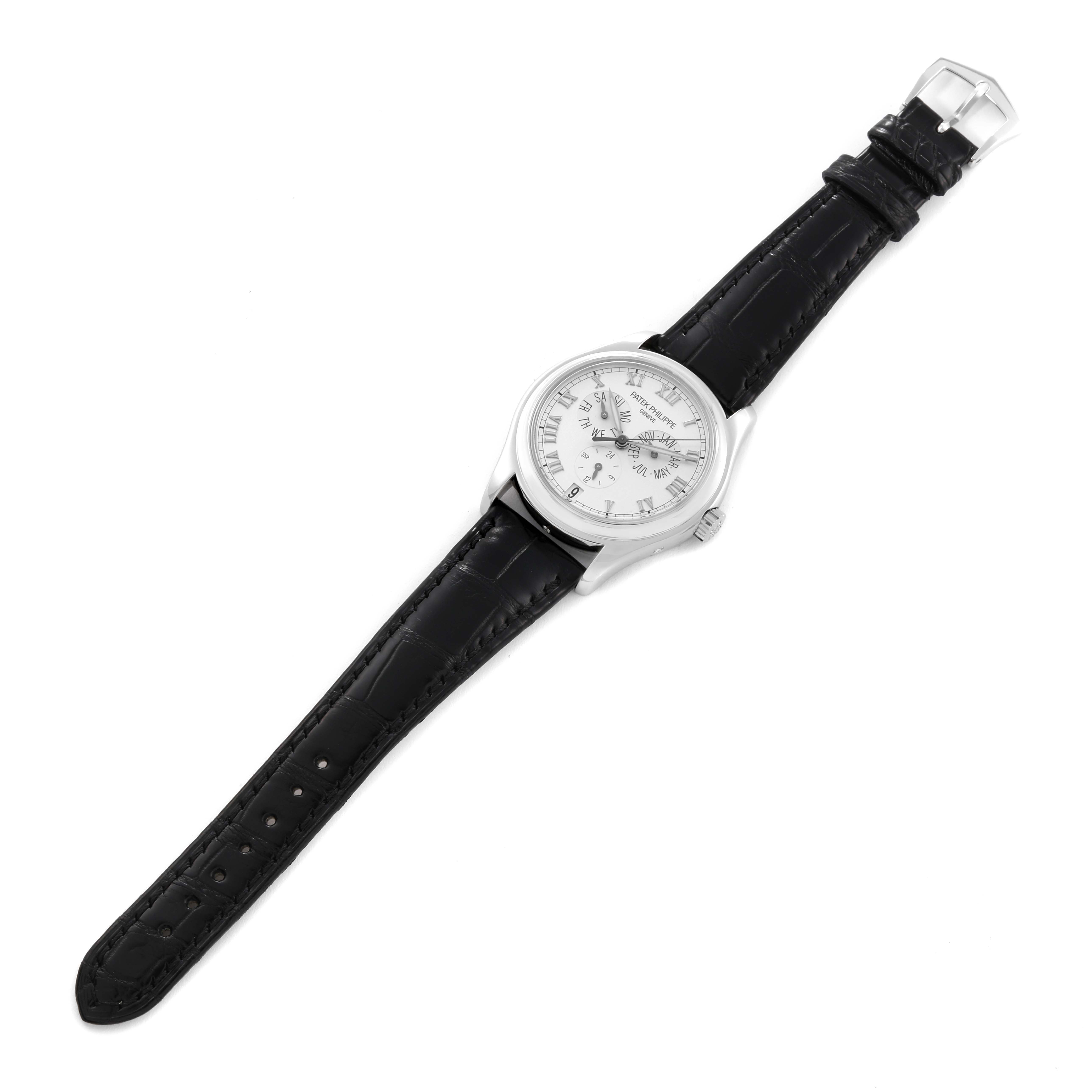 The Patek Philippe Complications 5035P-026 Men's Platinum Silver Dial 5035P-026 Men's Platinum Silver Dial model watch is pictured from a top-down angle, showing the face, bezel, crown, and black leather strap.