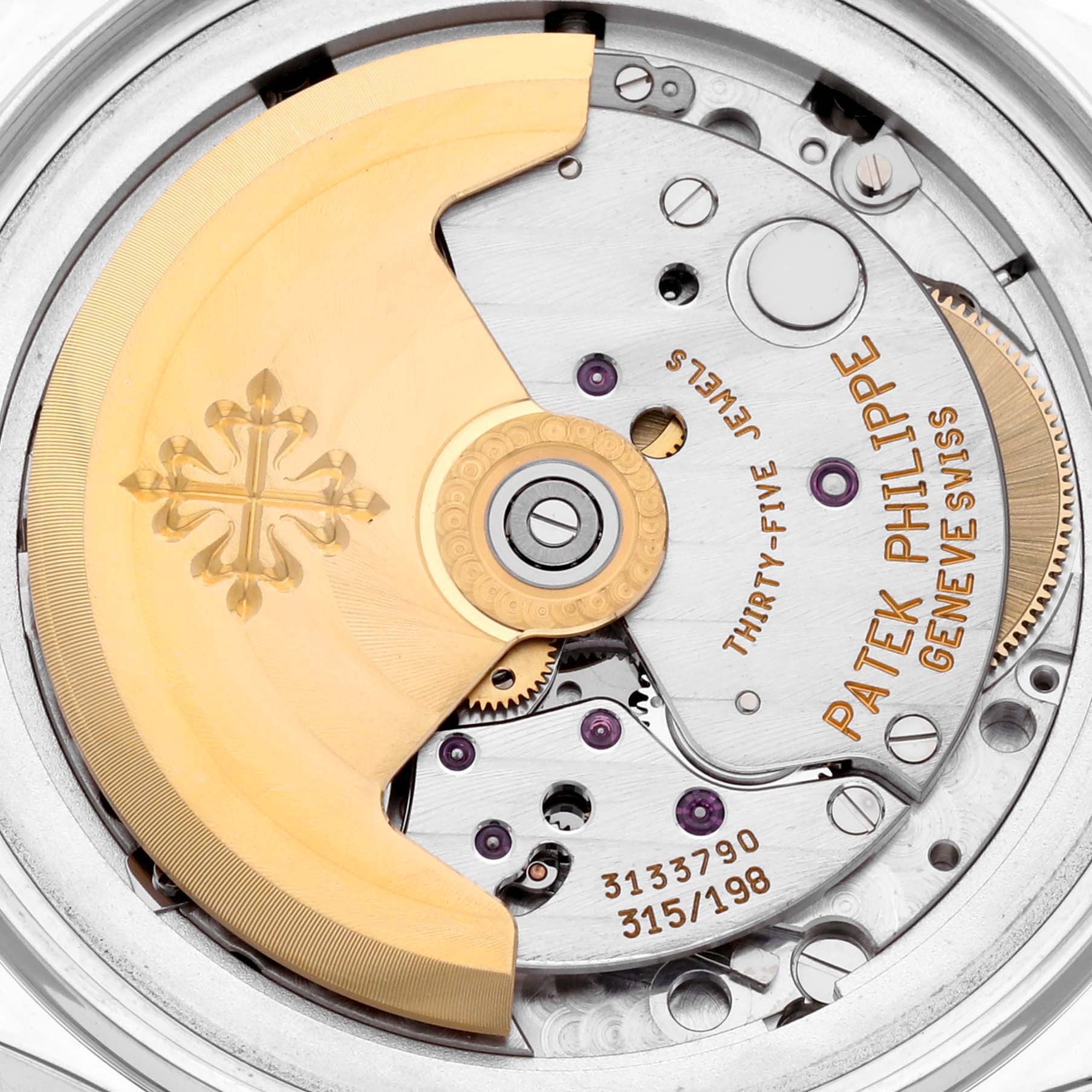 This close-up image shows the intricate movement parts of the Patek Philippe Complications 5035P-026 Men's Platinum Silver Dial 5035P-026 Men's Platinum Silver Dial watch, featuring the rotor and engraved details.