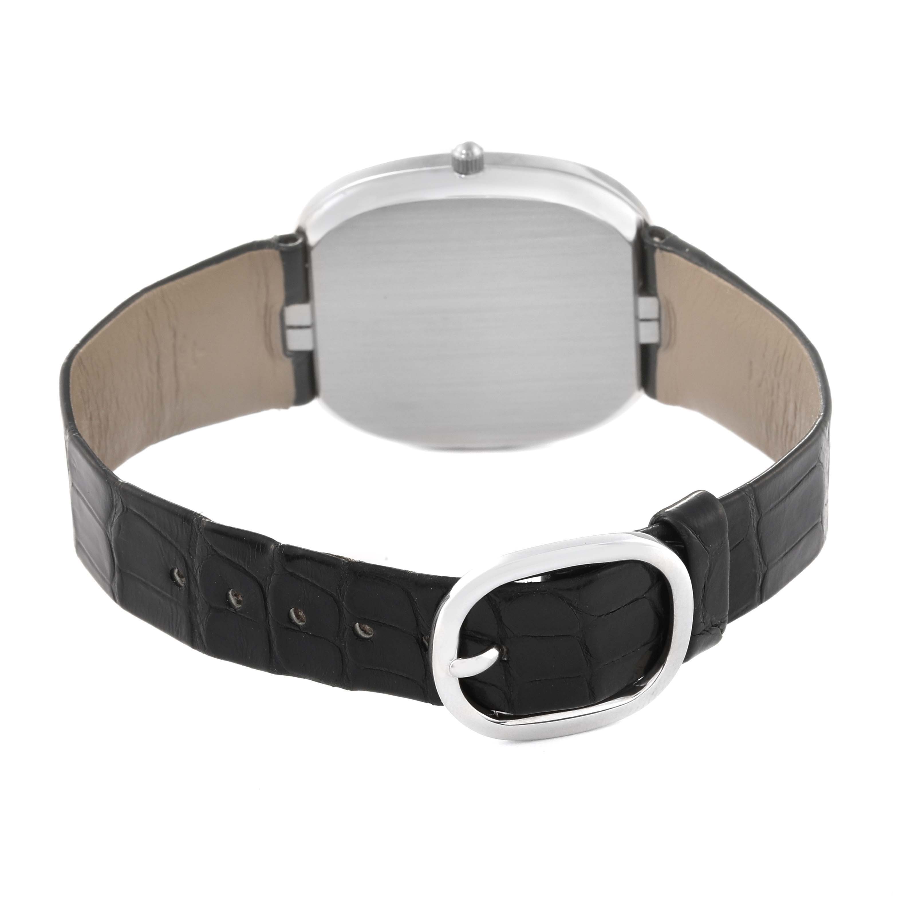 The image shows the back view of the Patek Philippe Golden Ellipse 5028G Men's White Gold Black Dial 5028G Men's White Gold Black Dial watch, highlighting the case back and leather strap with the buckle.