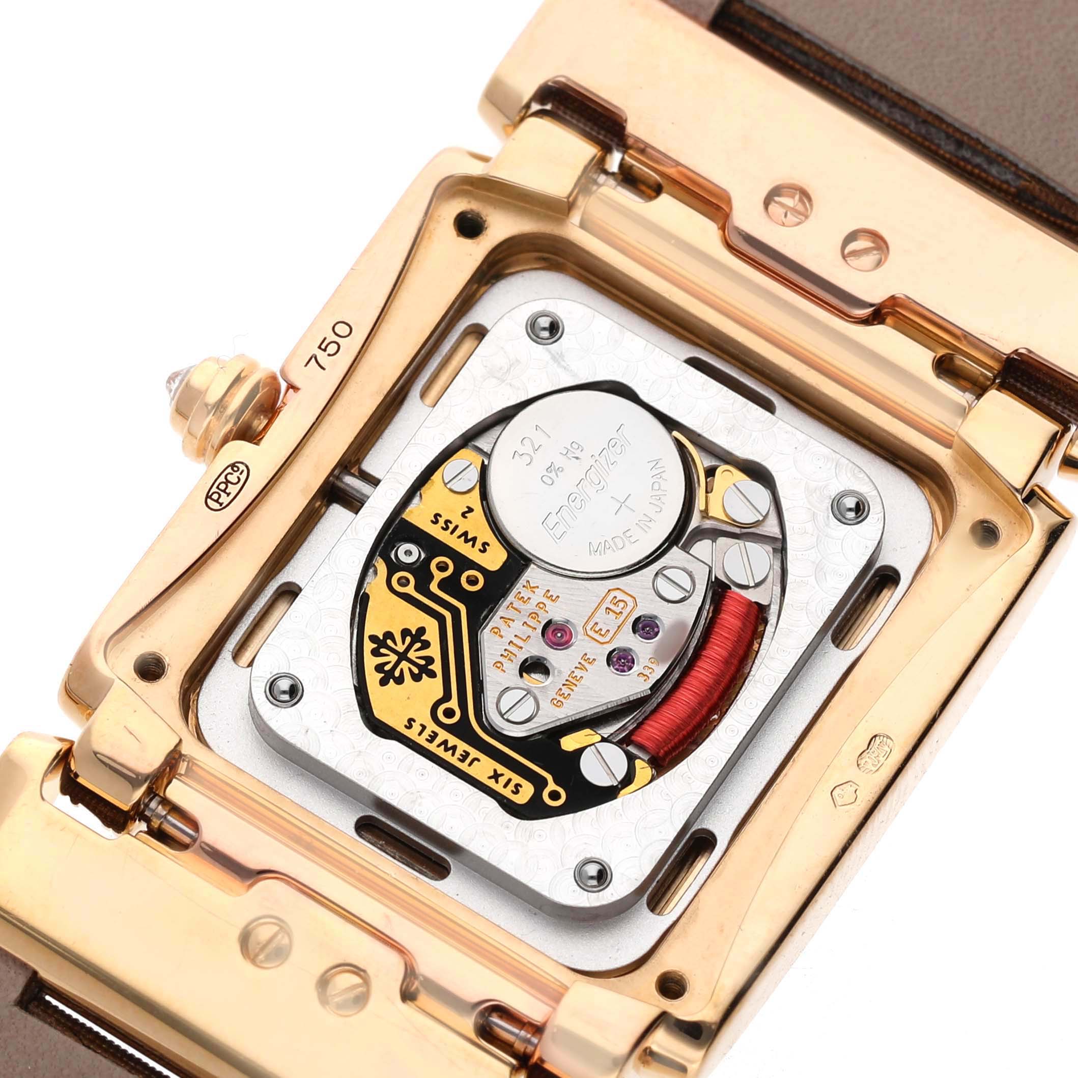 The image shows the open case back of the Patek Philippe Twenty-4 4920R-001 Women's Rose Gold Brown Dial model, highlighting its internal components and movement.