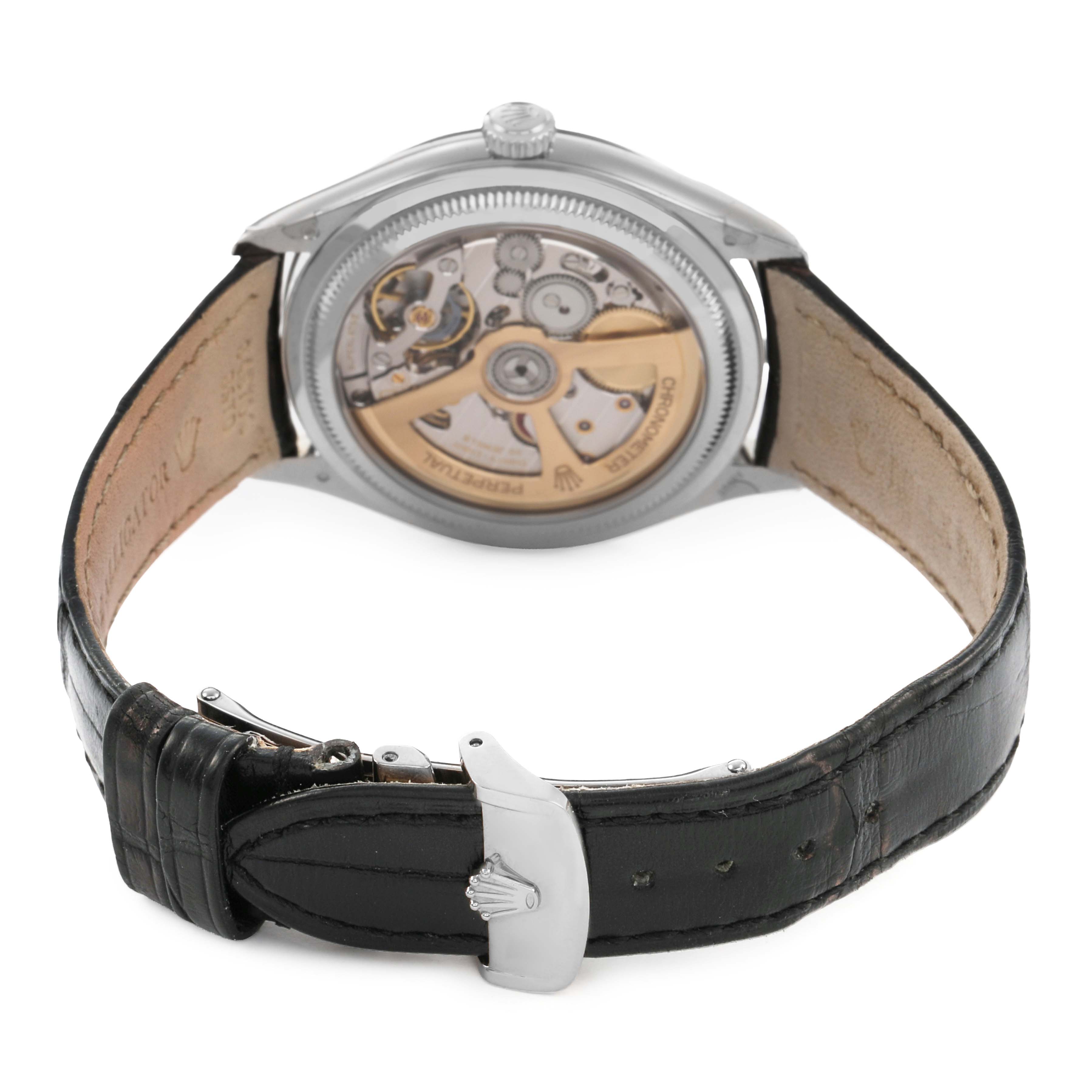 The image shows the Rolex 1908 52509 Men's White Gold Black Dial watch from the back, highlighting its movement and leather strap with a clasp.
