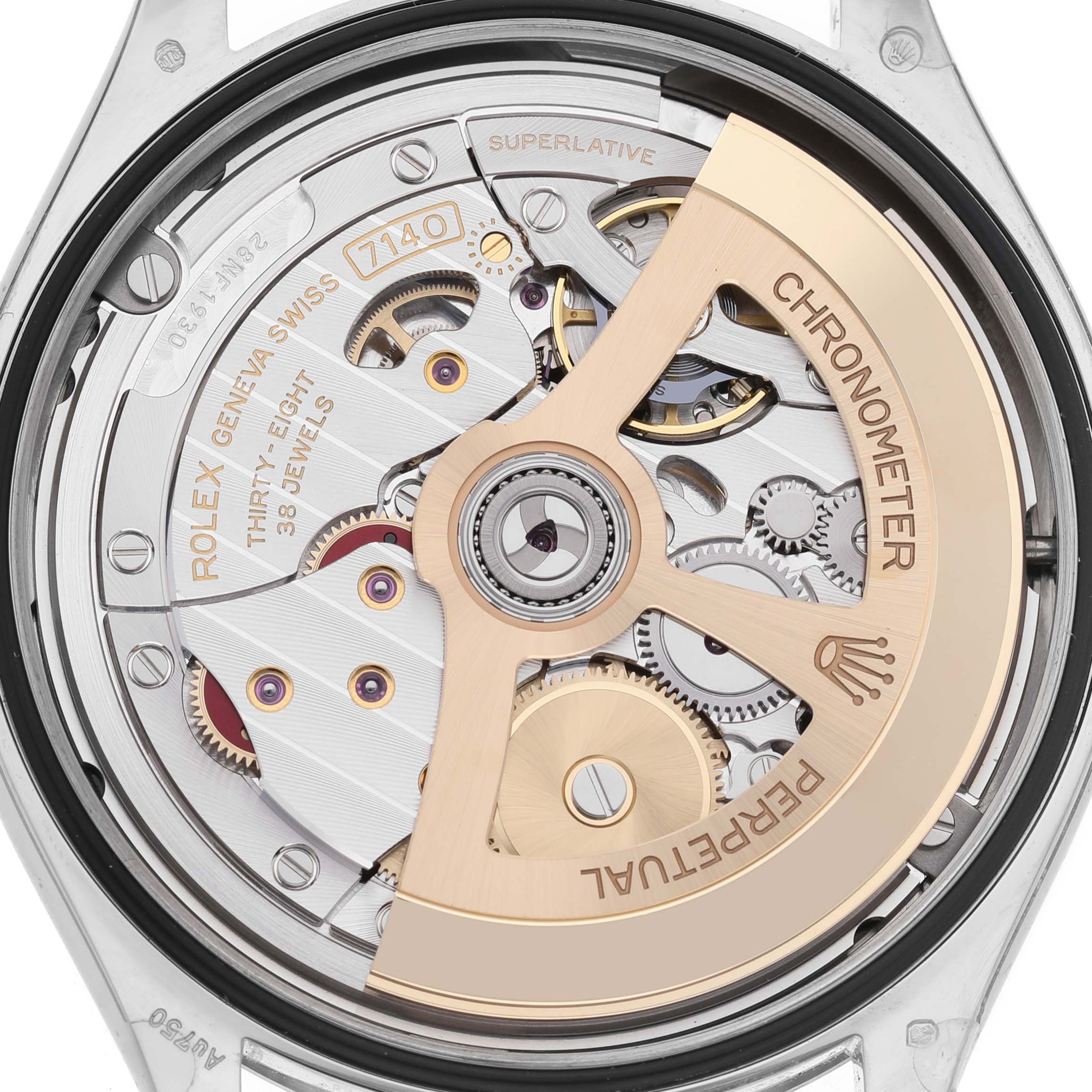 The image shows the intricate movement of the Rolex 1908 52509 Men's White Gold Black Dial model from a case-back view, highlighting gears and the rotor.