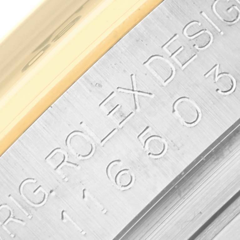 This close-up image shows the engraved serial number and "ROLEX DESIGN" text on the Daytona model by Rolex.