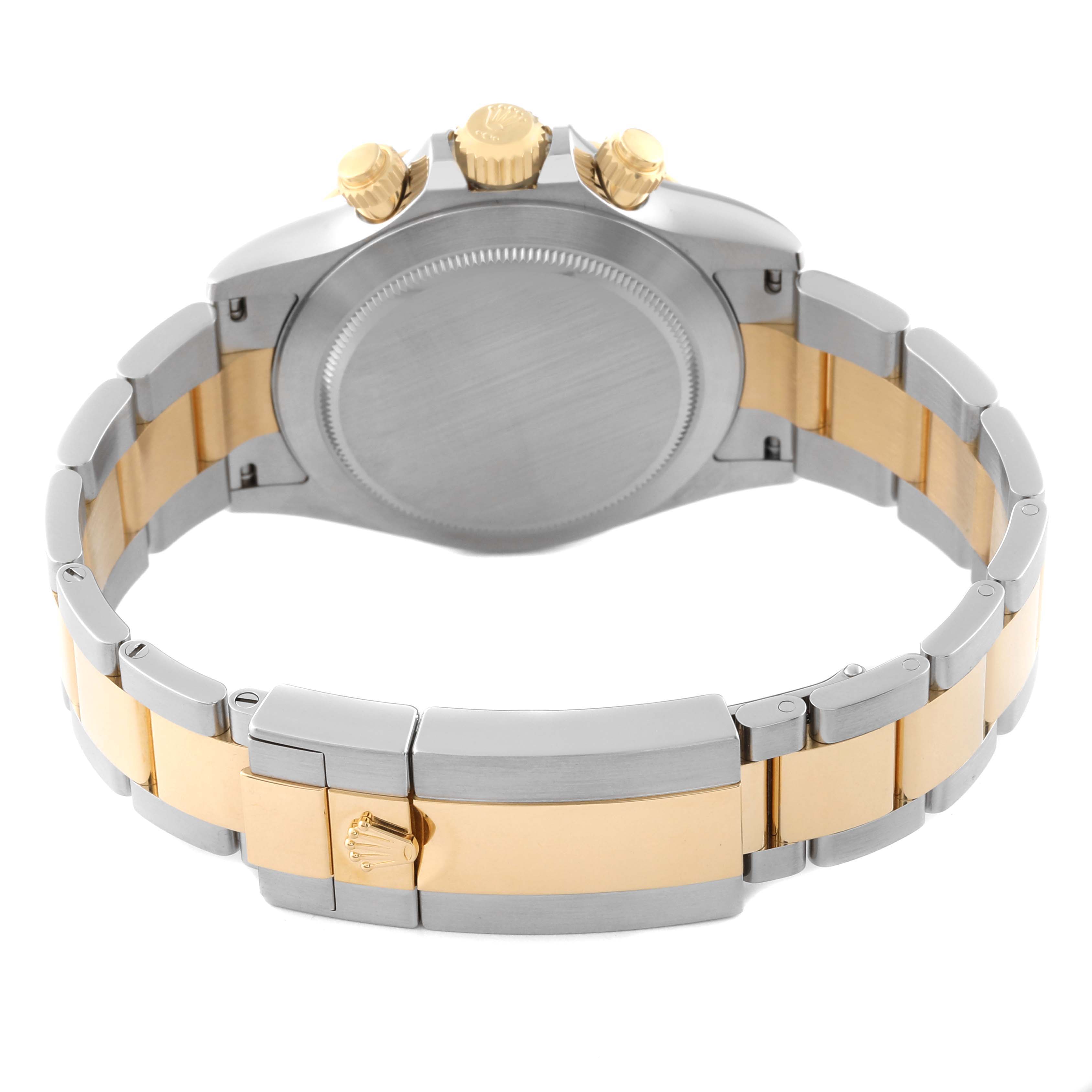 This image shows the back and clasp of a Rolex Daytona 116503 Men's Steel and Gold (two tone) Black Dial 116503 Men's Steel and Gold (two tone) Black Dial watch, highlighting the two-tone bracelet and gold crown.