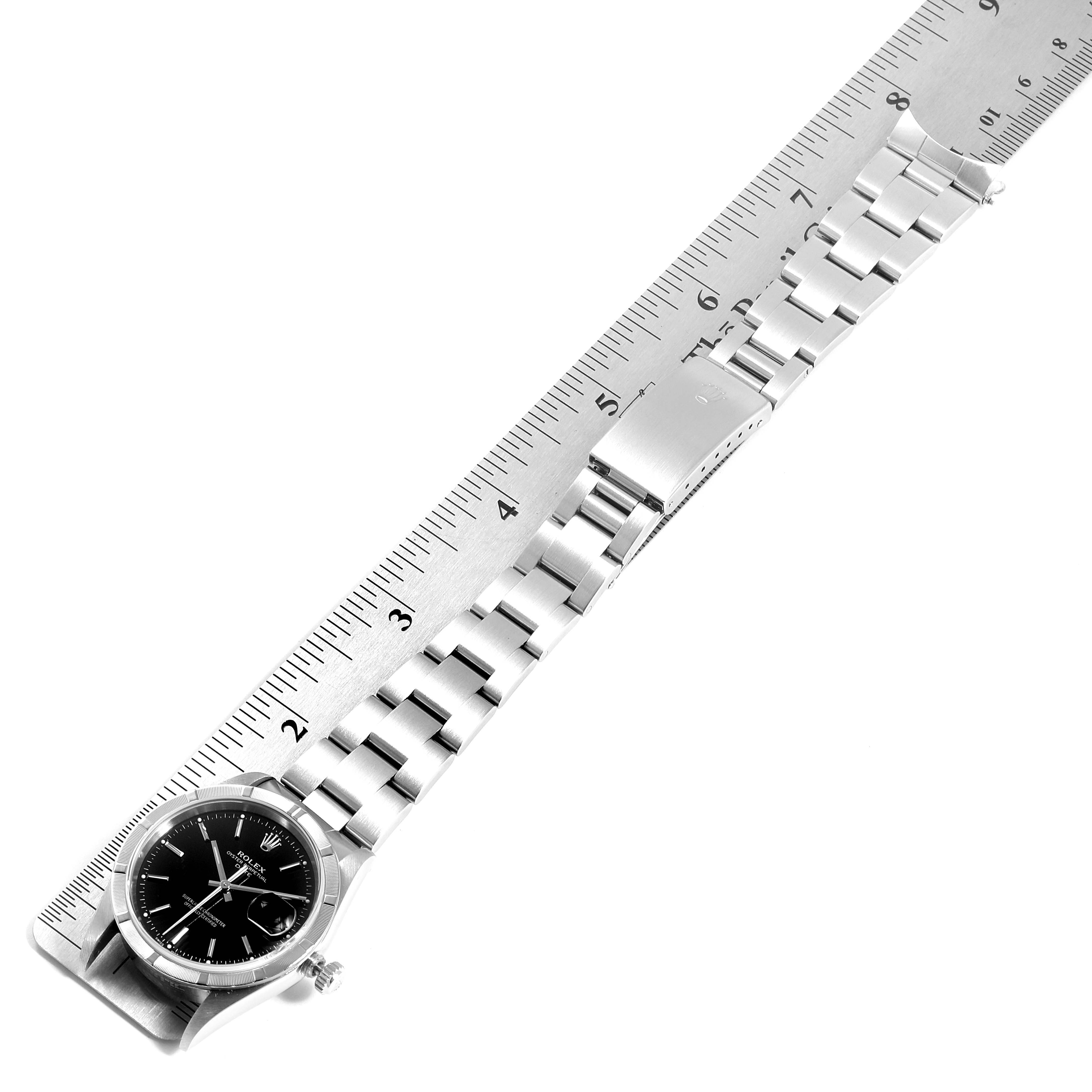 The image shows a Rolex Date 15210 Men's Stainless Steel Black Dial 15210 Men's Stainless Steel Black Dial model watch laid flat with a ruler, displaying the entire watch and bracelet.