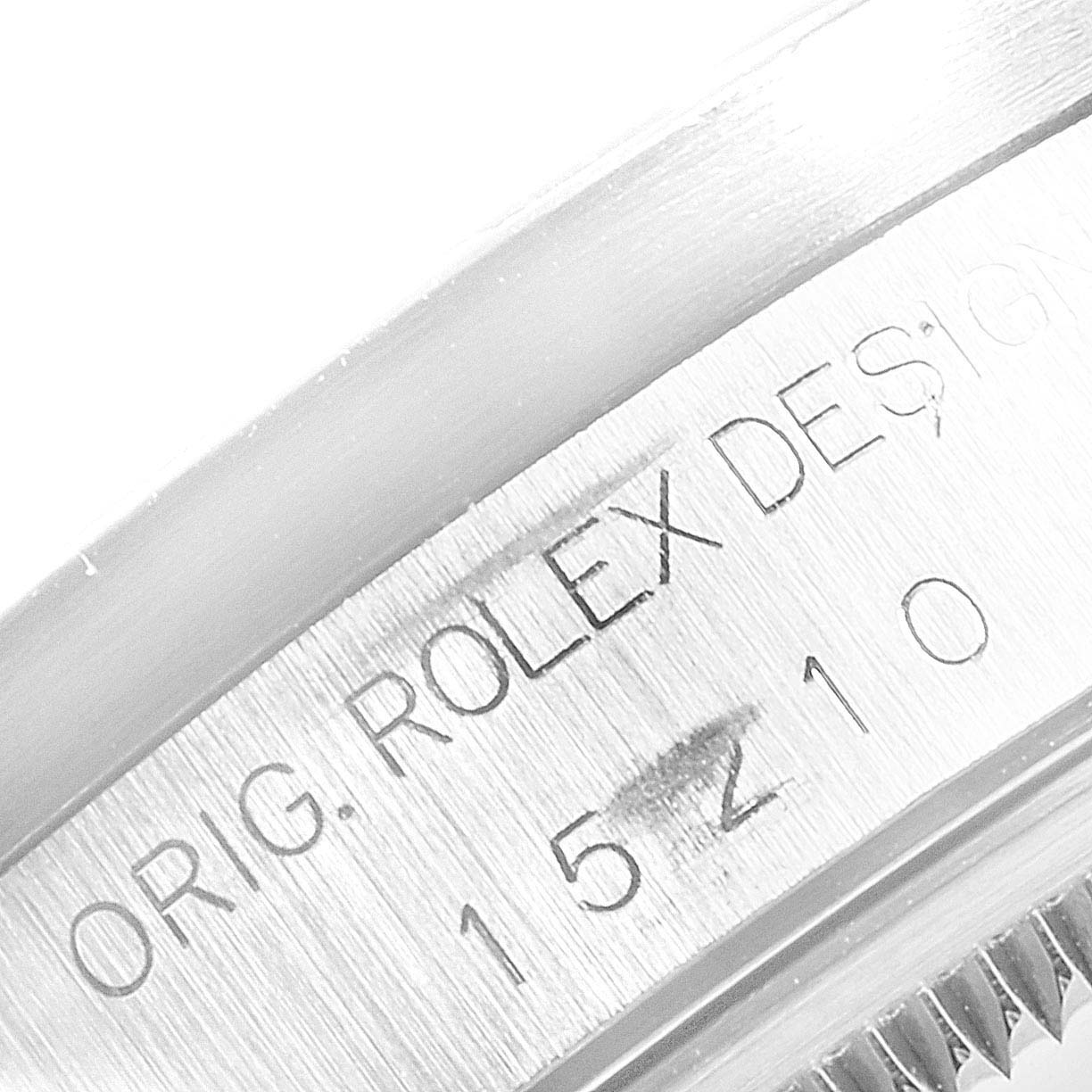 This is a close-up shot of the engraved casing showing the serial number on the Rolex Date 15210 Men's Stainless Steel Black Dial 15210 Men's Stainless Steel Black Dial model watch.
