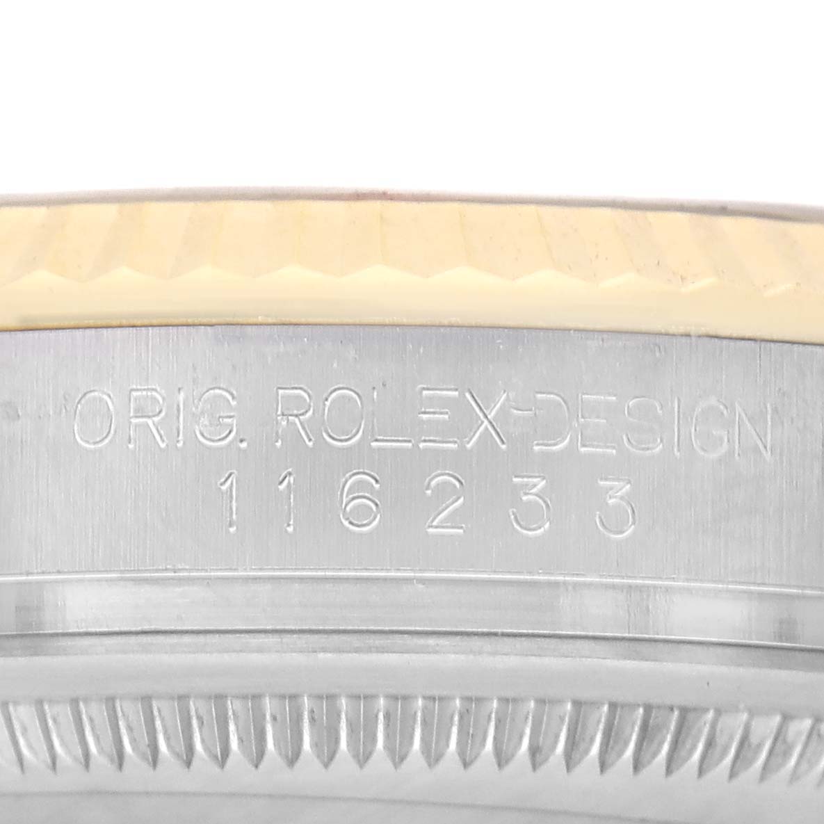 The image shows a close-up of the case side of a Rolex Datejust 116233 Men's Steel and Gold (two tone) Silver Dial, featuring engraved branding and model number.