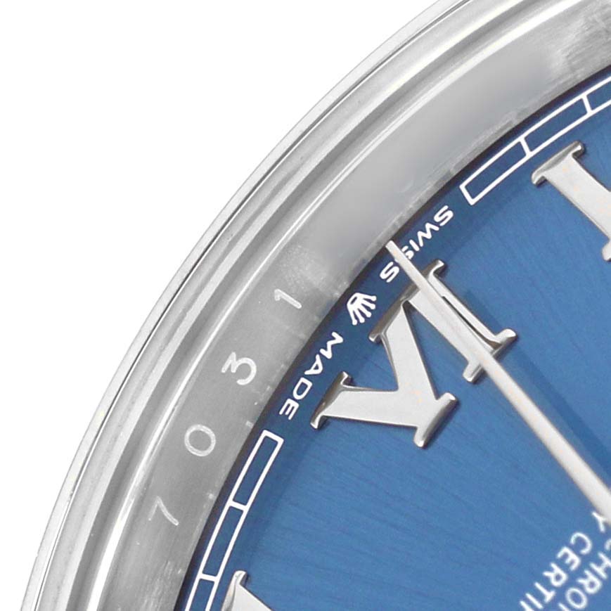 The image shows a close-up of the Rolex Datejust 126300 Men's Stainless Steel Blue Dial with a partial view of the blue dial, Roman numerals, and minute markers.