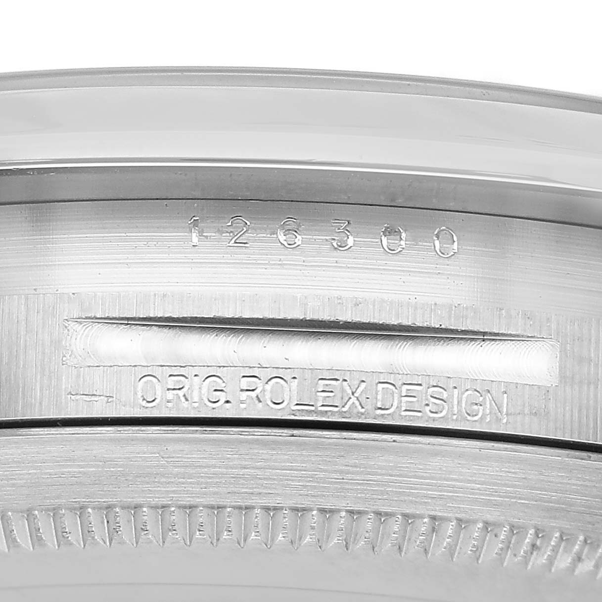 The image shows a close-up of the case edge of a Rolex Datejust 126300 Men's Stainless Steel Blue Dial, highlighting the model number and "Orig Rolex Design" engraving.