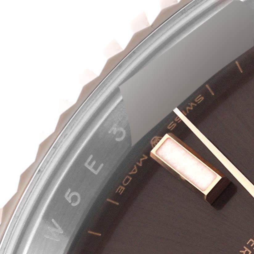 This close-up image of a Rolex Datejust 41 126331 Men's Steel and Gold (two tone) Brown Dial 126331 Men's Steel and Gold (two tone) Brown Dial showcases part of the dial and the fluted bezel.
