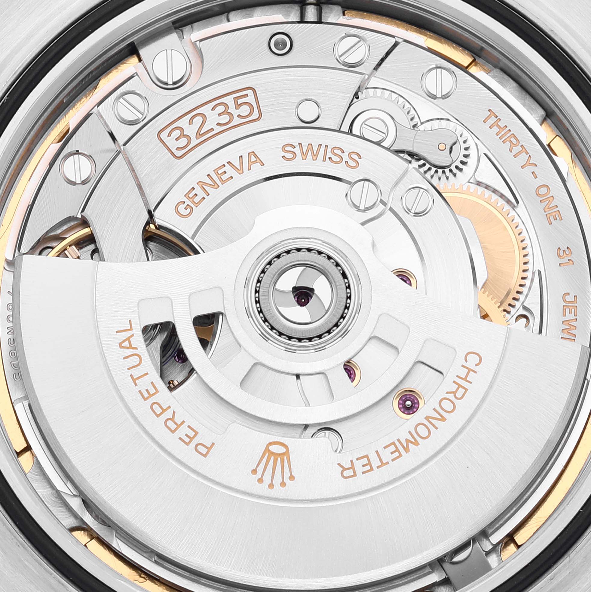 The image shows a close-up of the movement inside the Rolex Datejust 41 126331 Men's Steel and Gold (two tone) Brown Dial 126331 Men's Steel and Gold (two tone) Brown Dial watch, highlighting the rotor and plates with engravings.