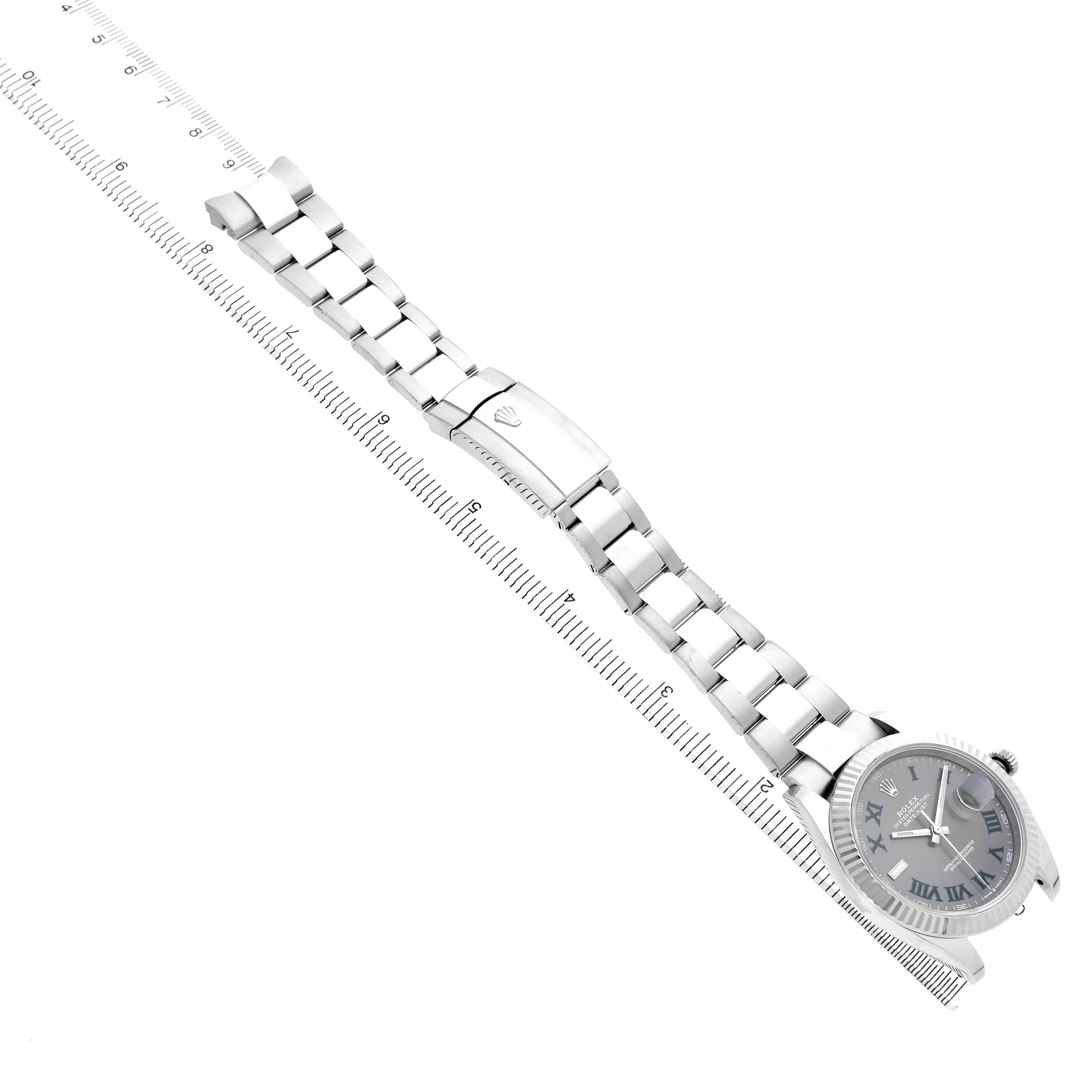 The Rolex Datejust 41 126334 Men's Stainless Steel Grey Dial is shown at an angle displaying the full bracelet and part of the case, positioned along a ruler.
