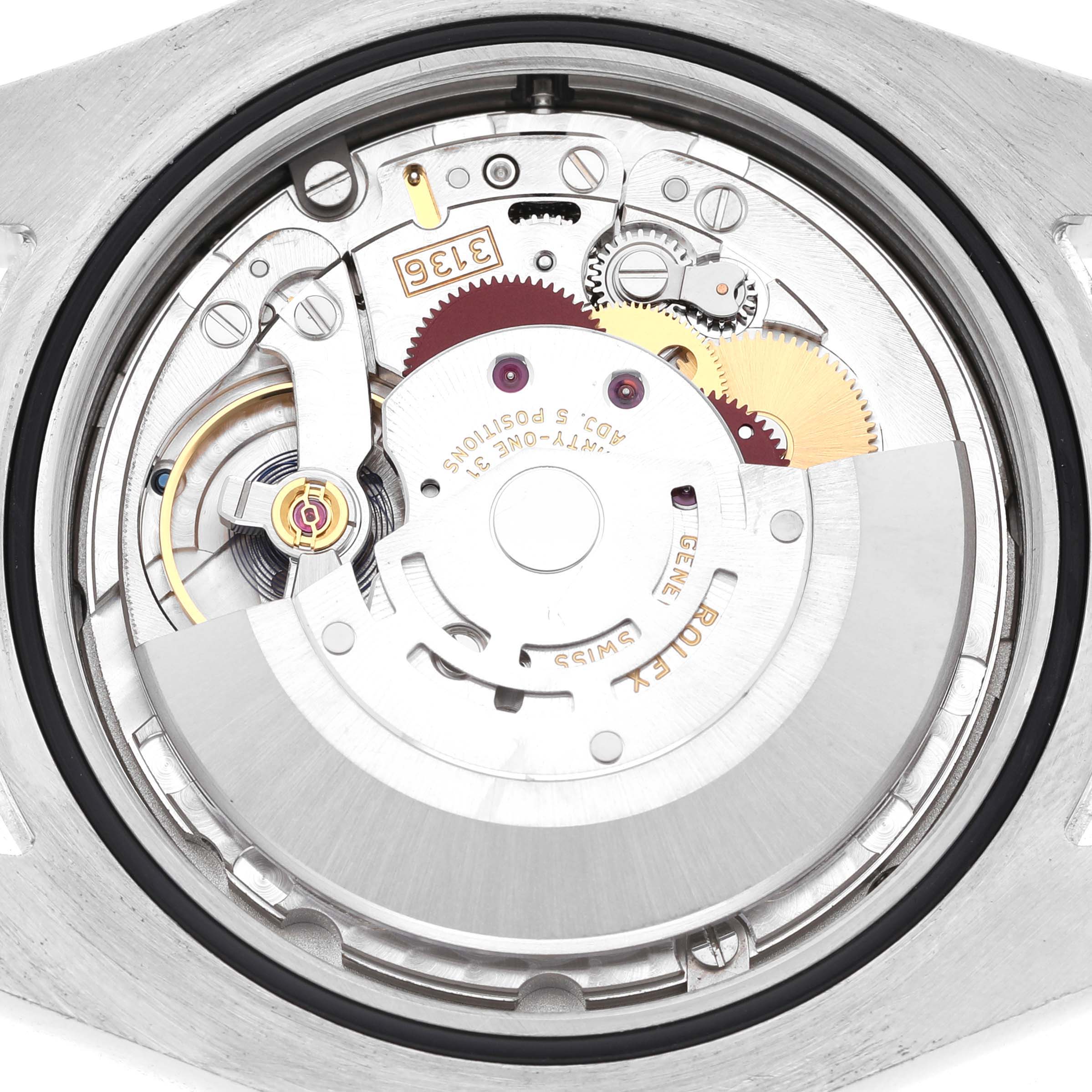 The image shows the movement of a Rolex Datejust 41 116300 Men's Stainless Steel Black Dial watch from the back, highlighting gears and components.