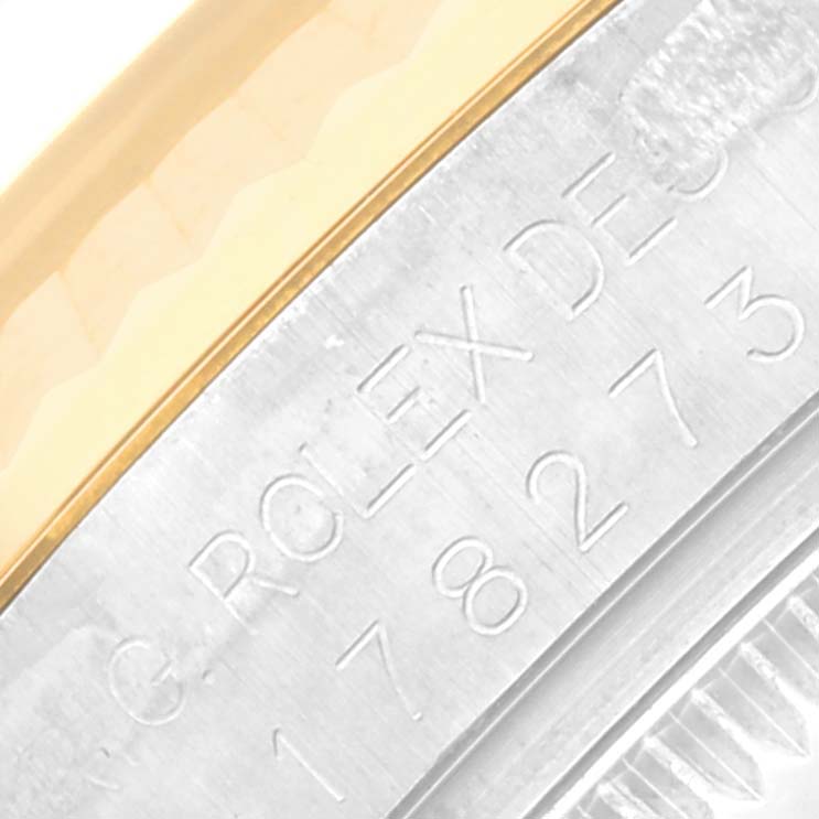 The image shows a close-up of the case back edge with the engraved text on a Mid-Size Rolex watch.