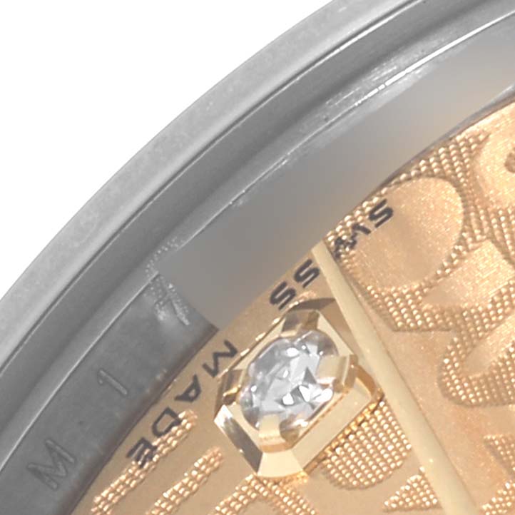 This image shows a close-up of a diamond marker and part of the dial from the Mid-Size Rolex watch.