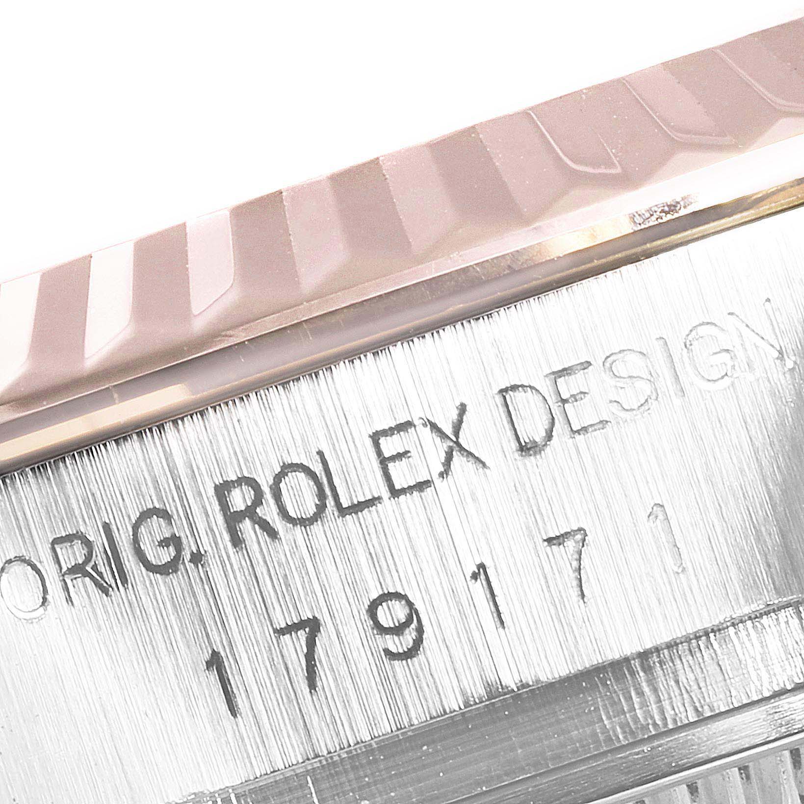This image shows a close-up of the side of a Rolex Datejust 179171 Women's Steel and Gold (two tone) Black Dial 179171 Women's Steel and Gold (two tone) Black Dial watch, highlighting its serial number and "Rolex Design" inscription.