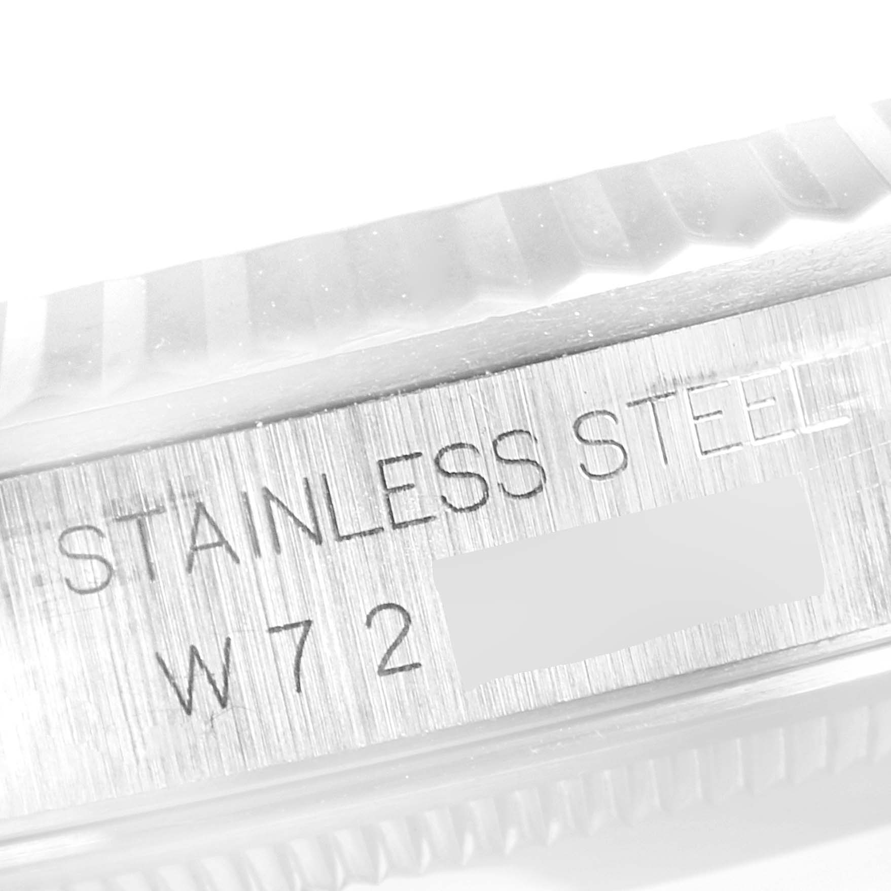 The image shows a close-up of the side of the Rolex Datejust 16234 Men's Stainless Steel Blue Dial 16234 Men's Stainless Steel Blue Dial watch, highlighting its stainless steel marking and partial serial number.