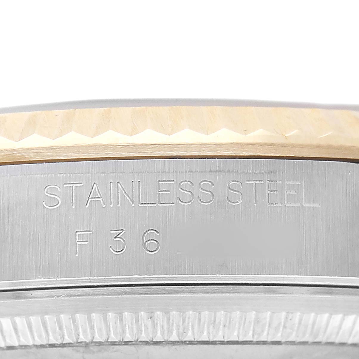 The image shows the side profile of a Rolex Datejust 116233 Men's Steel and Gold (two tone) Champagne Dial, highlighting the stainless steel case with engraved markings.