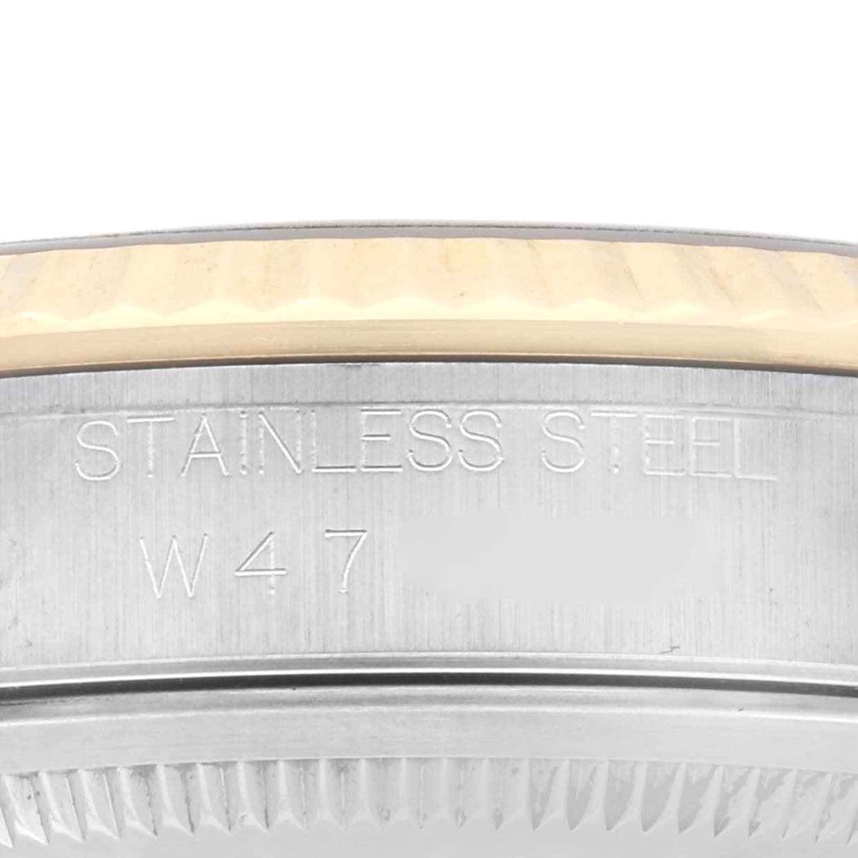 This image shows a close-up of the bezel and side of a stainless steel Rolex Datejust 16233 Men's Stainless Steel Champagne Dial 16233 Men's Stainless Steel Champagne Dial watch with engraving.