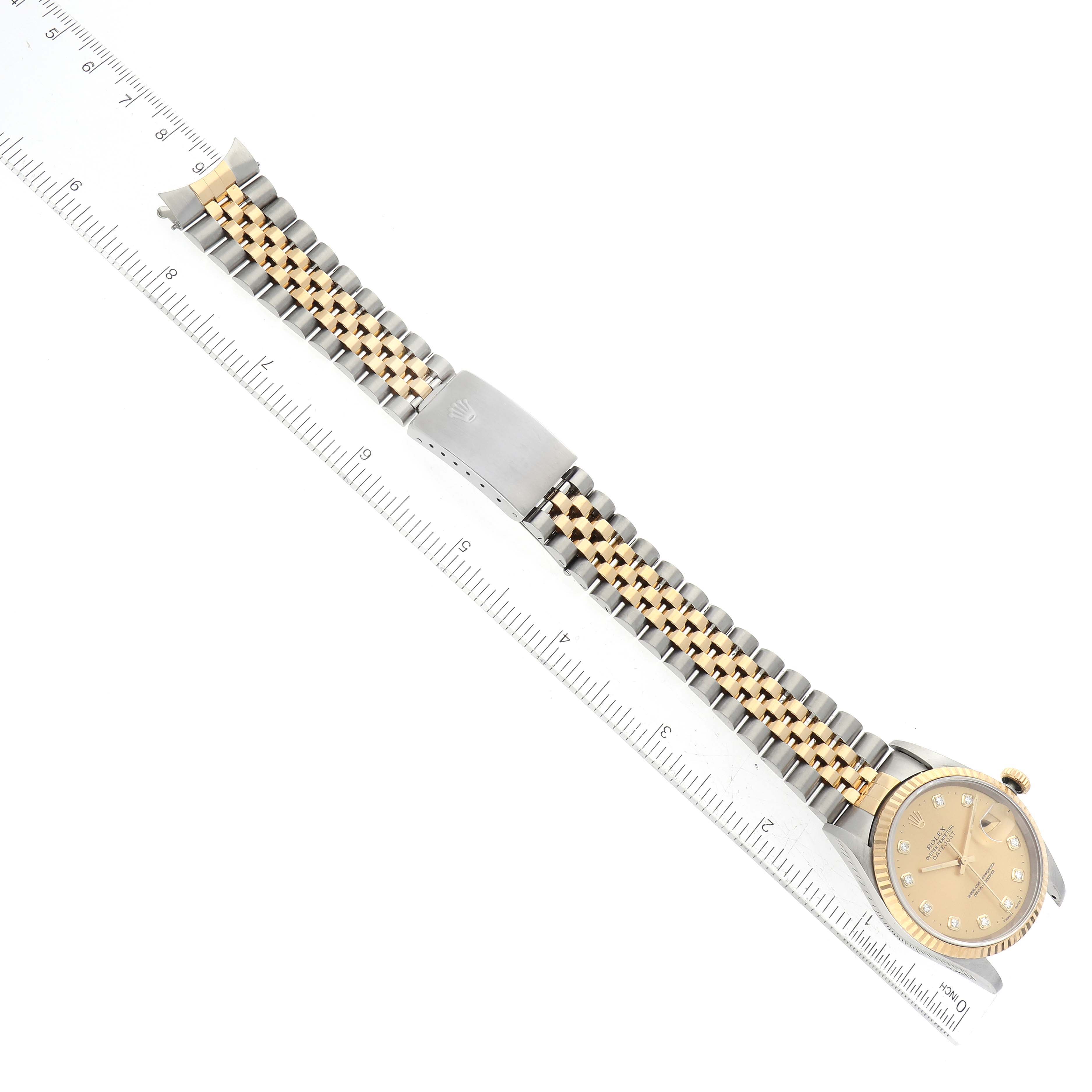 The image shows a Rolex Datejust 16233 Men's Stainless Steel Champagne Dial 16233 Men's Stainless Steel Champagne Dial watch laid flat next to a ruler with its entire band and face visible from a top view.