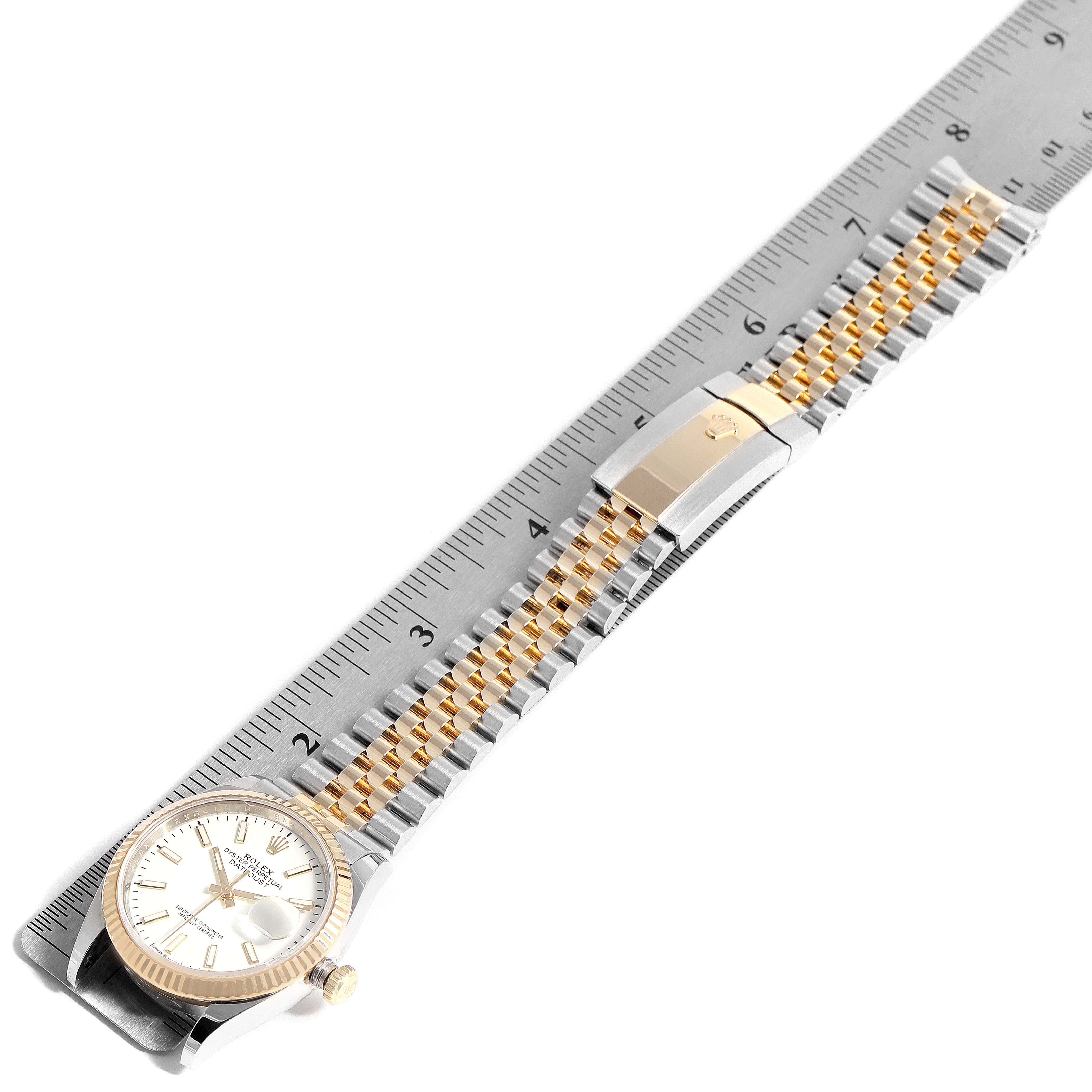 The image shows a side angle of a gold and silver bracelet for a Rolex Datejust 126233 Men's Steel and Gold (two tone) White Dial 126233 Men's Steel and Gold (two tone) White Dial watch, placed on a ruler for measurement.