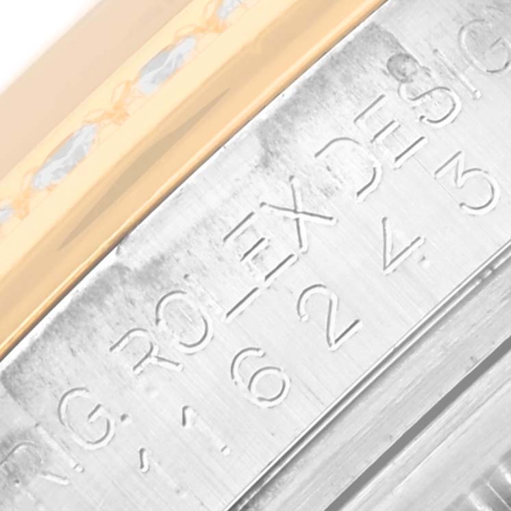 The image shows a close-up of the engraved inner bezel ring of a Rolex Datejust 116243 Men's Steel and Gold (two tone) Mother of Pearl Dial 116243 Men's Steel and Gold (two tone) Mother of Pearl Dial watch.