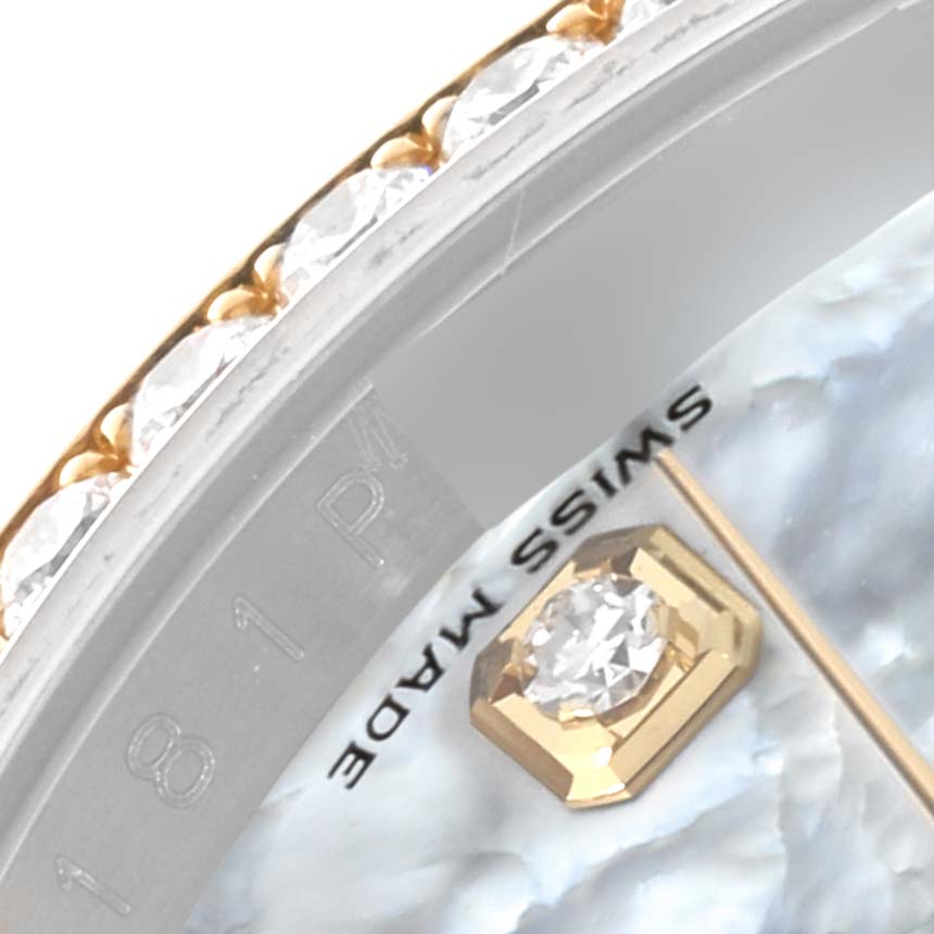 This image shows the bezel adorned with diamonds and part of the dial of a Rolex Datejust 116243 Men's Steel and Gold (two tone) Mother of Pearl Dial 116243 Men's Steel and Gold (two tone) Mother of Pearl Dial watch.