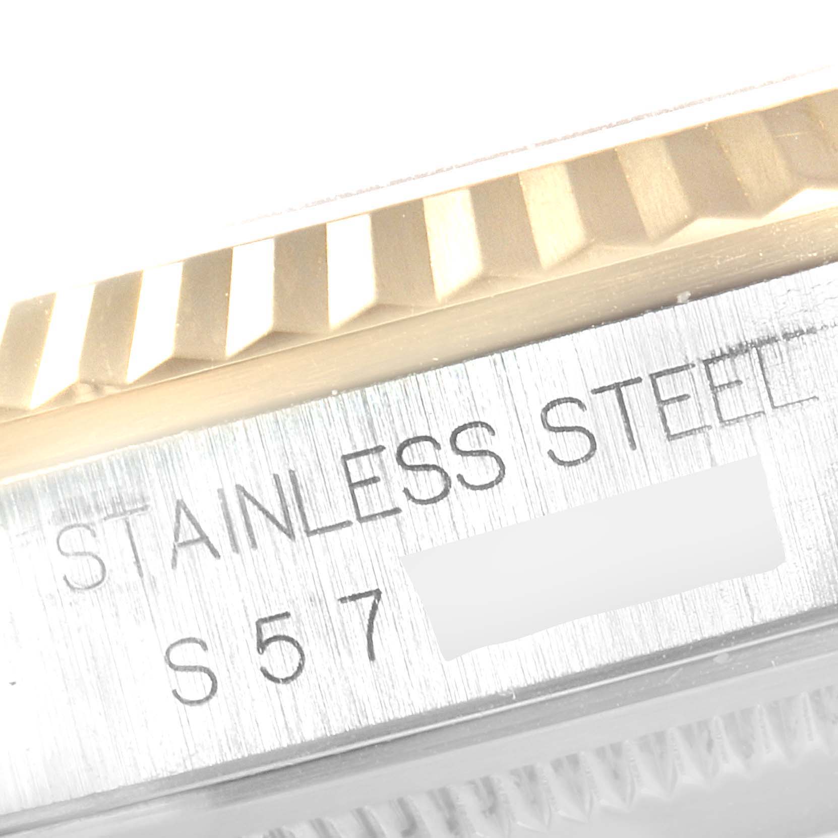 The image shows a close-up of the bezel and engraved stainless steel case of a Rolex Datejust 16233 Men
s Steel and Gold (two tone) Grey Dial 16233 Men
s Steel and Gold (two tone) Grey Dial watch.